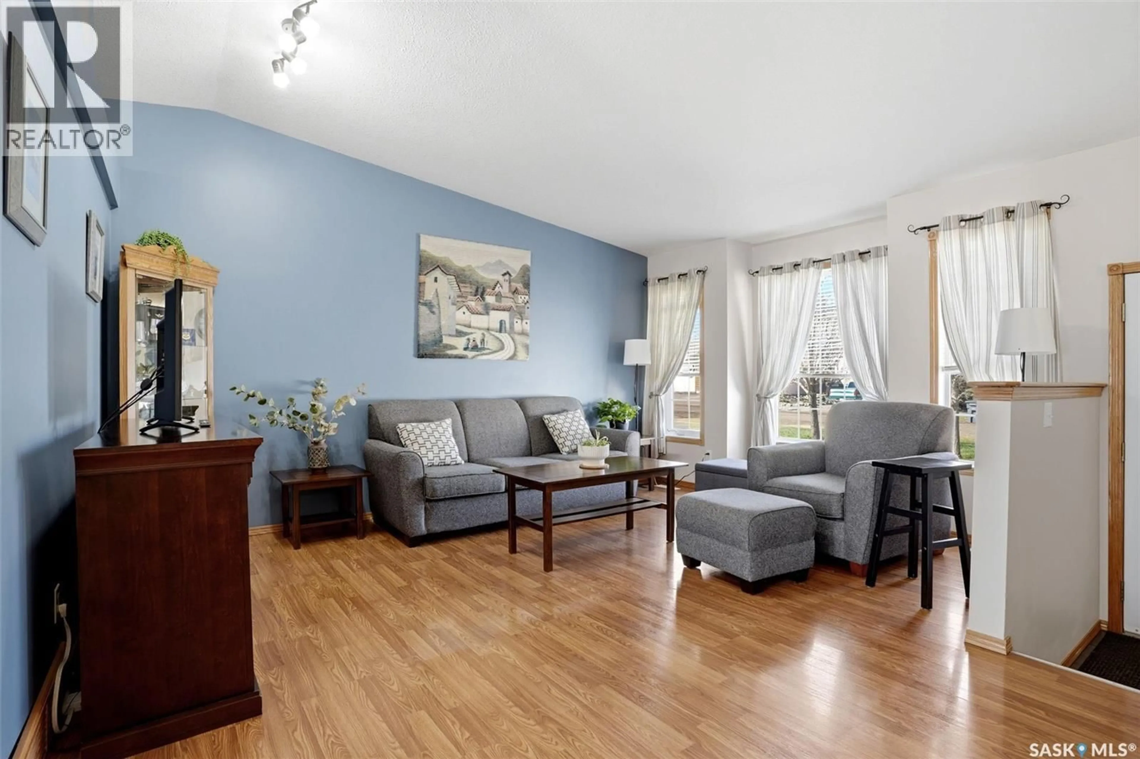 Living room with furniture, wood/laminate floor for 61 WILFRED STREET, Grand Coulee Saskatchewan S4M0A3