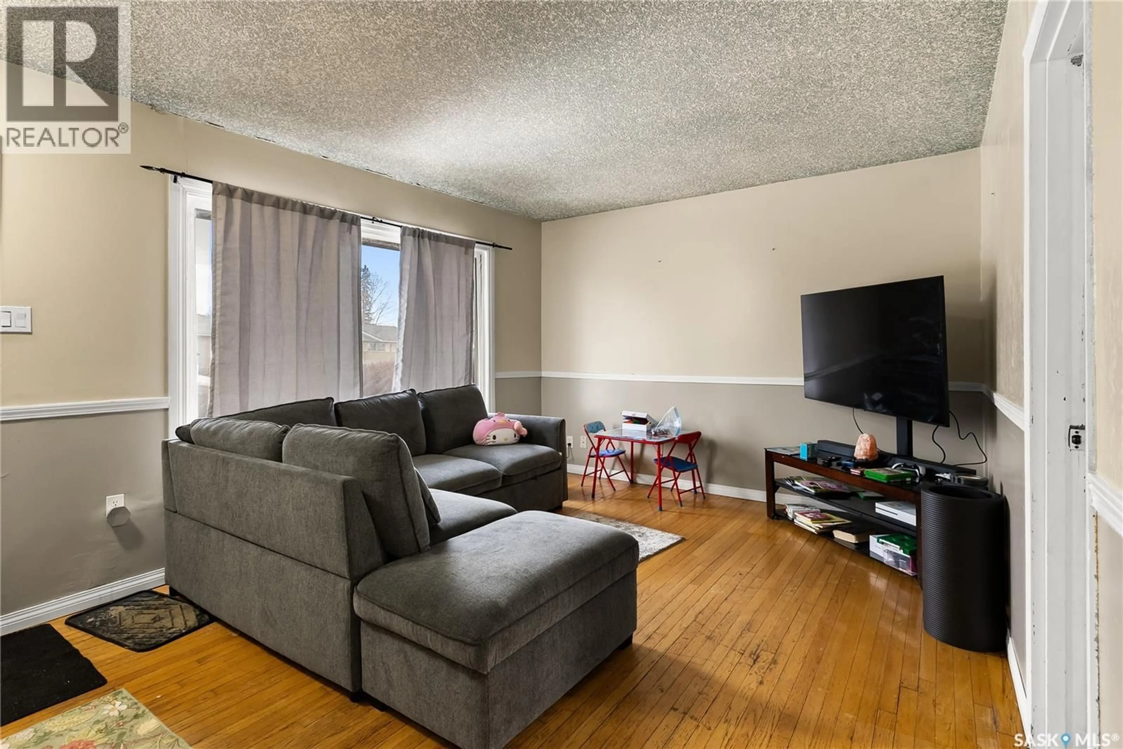 Living room with furniture, wood/laminate floor for 1561 REGENT STREET, Regina Saskatchewan S4N1S1