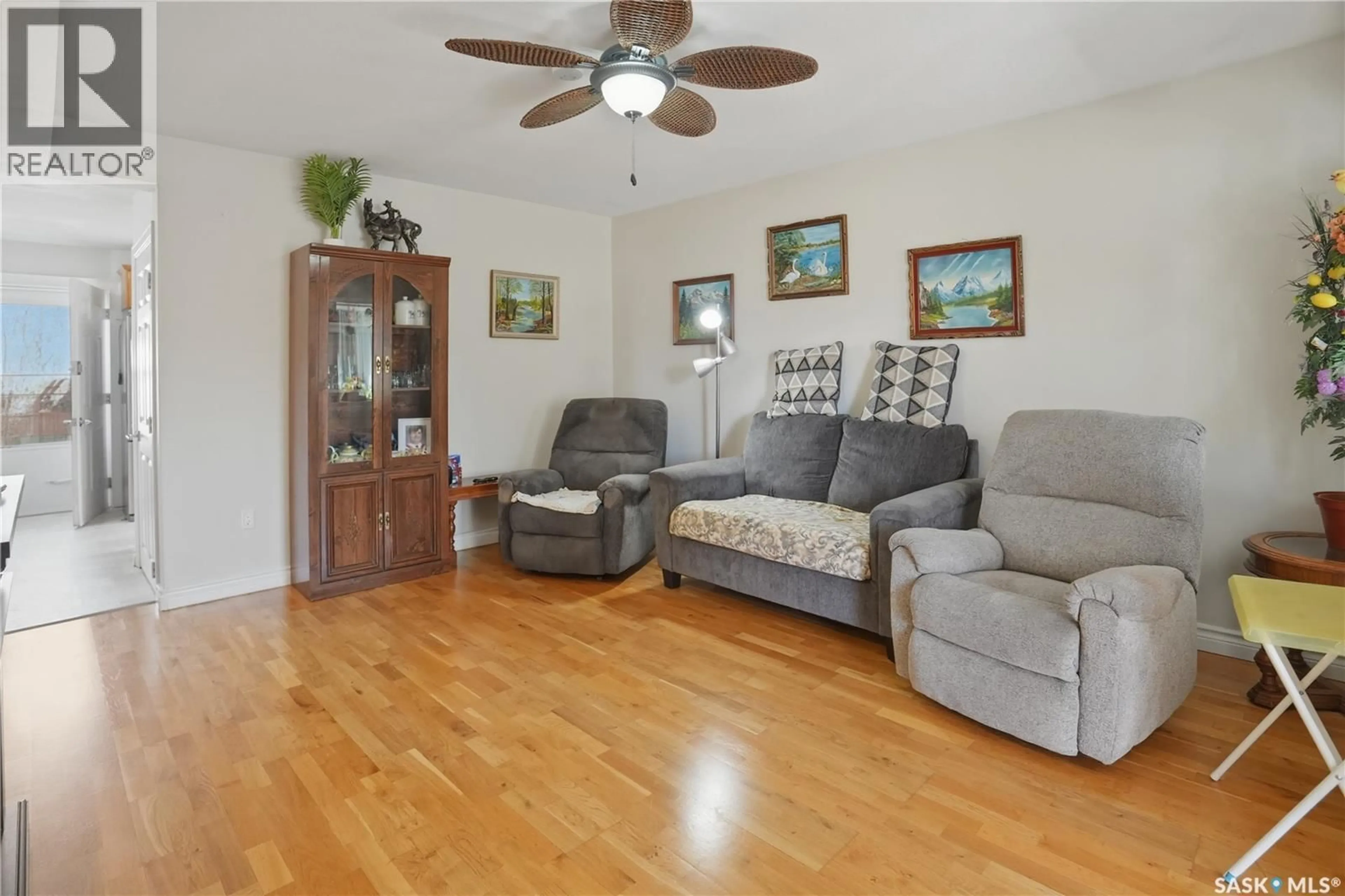 Living room with furniture, wood/laminate floor for 1472 103RD STREET, North Battleford Saskatchewan S9A1L3