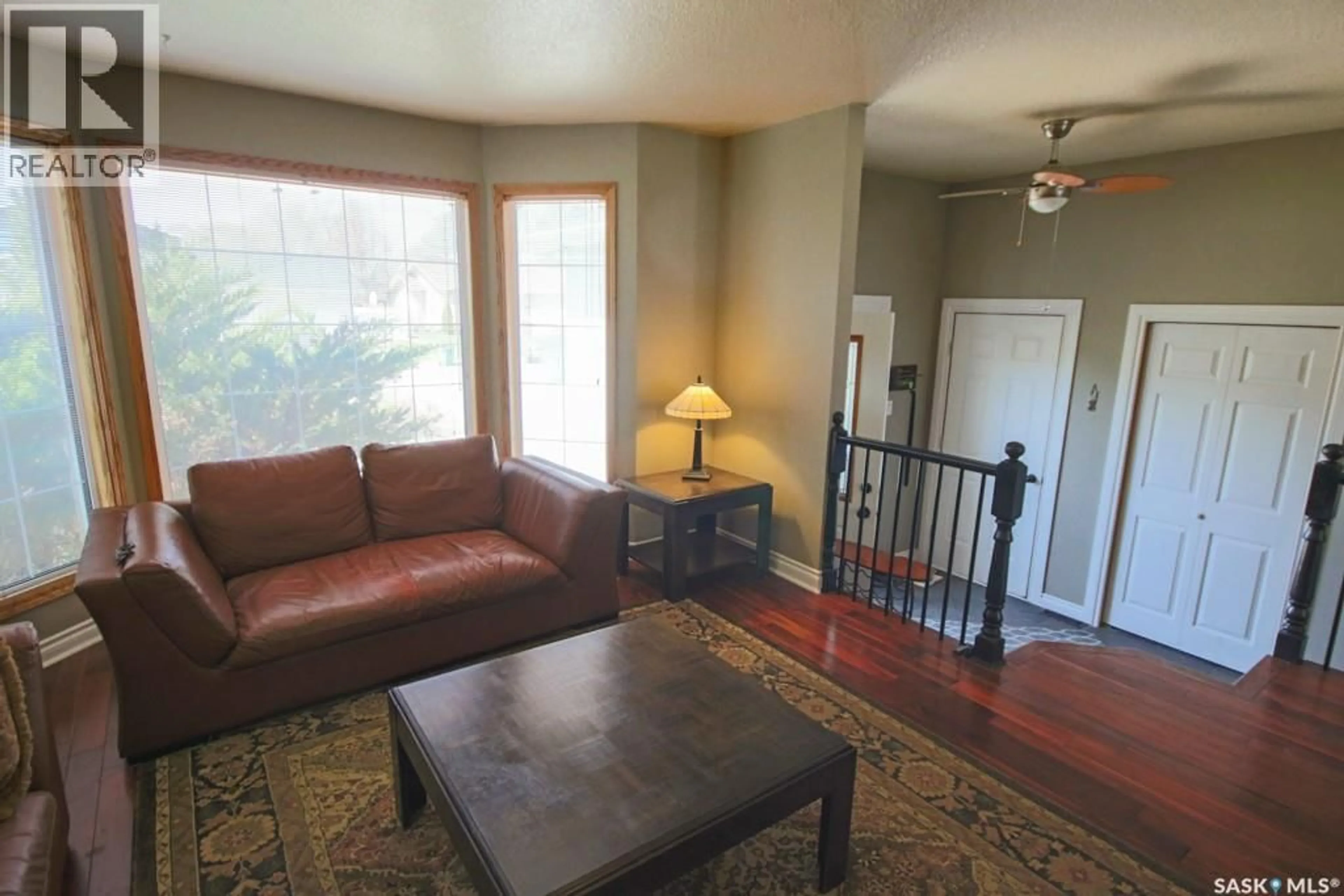 Living room with furniture, wood/laminate floor for 1666 MARSHALL CRESCENT, Moose Jaw Saskatchewan S6H3G7