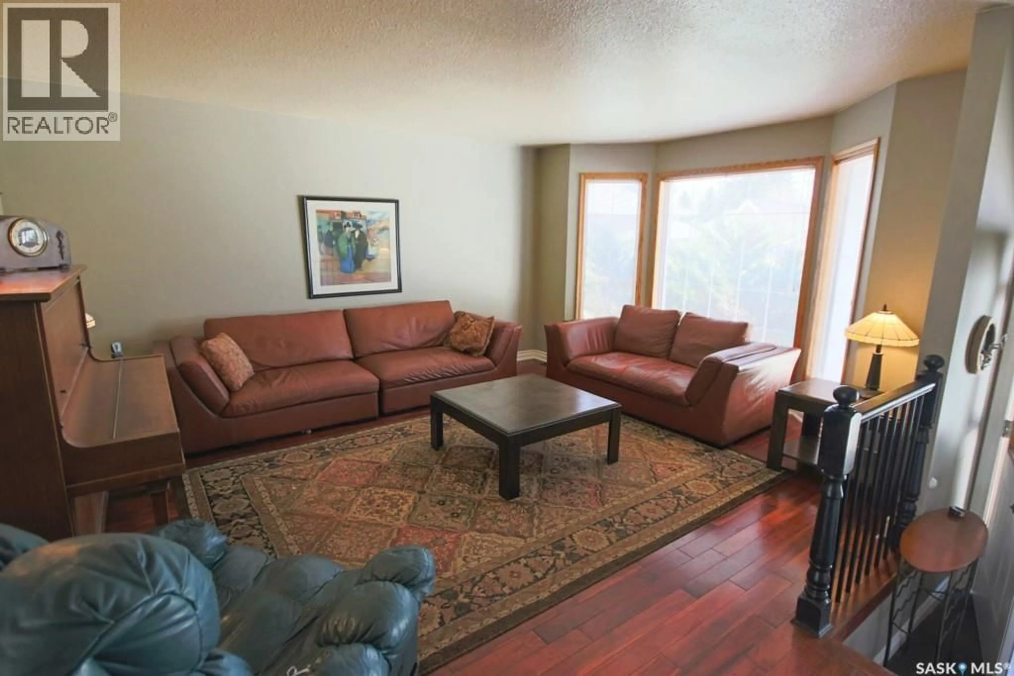 Living room with furniture, wood/laminate floor for 1666 MARSHALL CRESCENT, Moose Jaw Saskatchewan S6H3G7