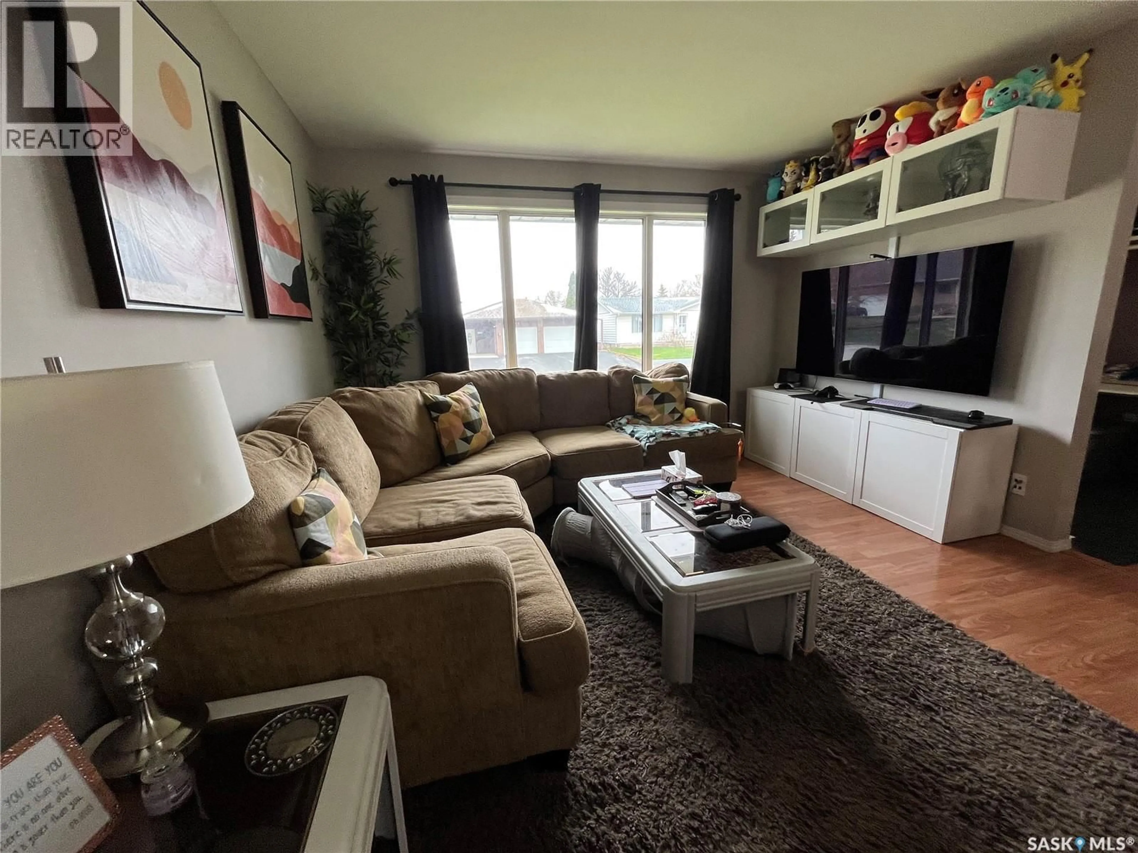 Living room with furniture, wood/laminate floor for 1001 CARLTON DRIVE, Esterhazy Saskatchewan S0A0X0