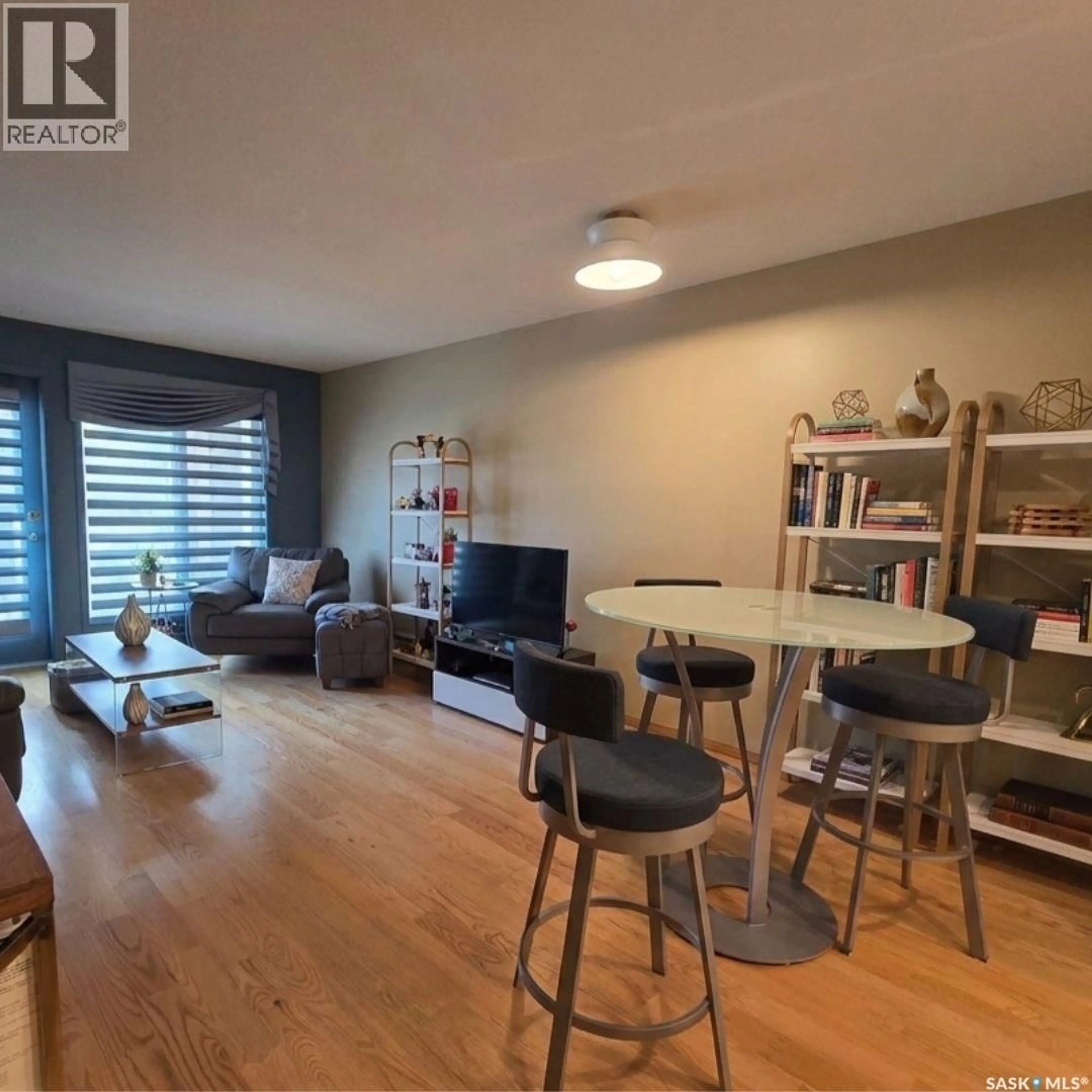 Living room with furniture, wood/laminate floor for 205 - 2244 SMITH STREET, Regina Saskatchewan S4P2P4