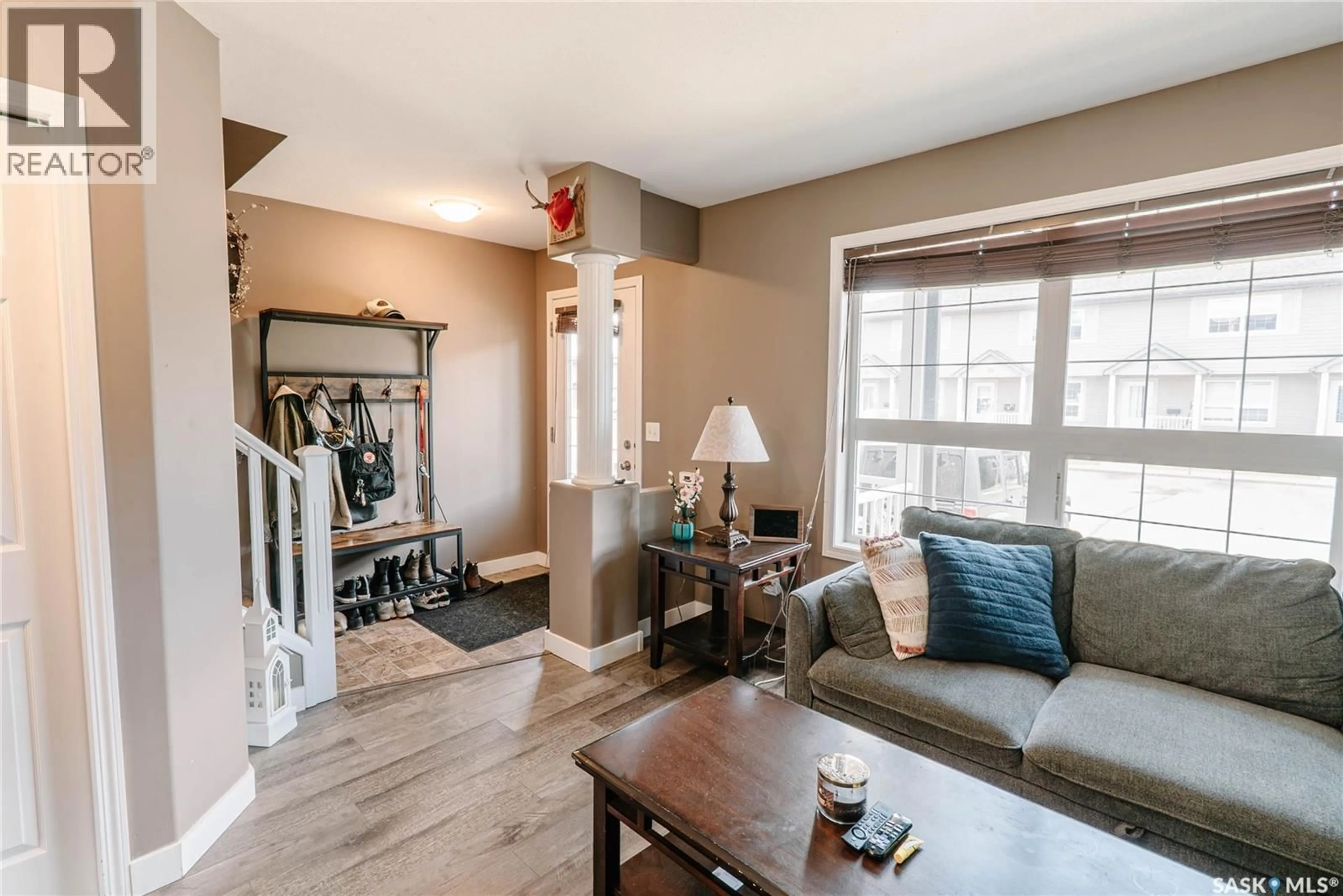 Living room with furniture, wood/laminate floor for 10 - 300 MACCORMACK ROAD, Martensville Saskatchewan S0K0A2