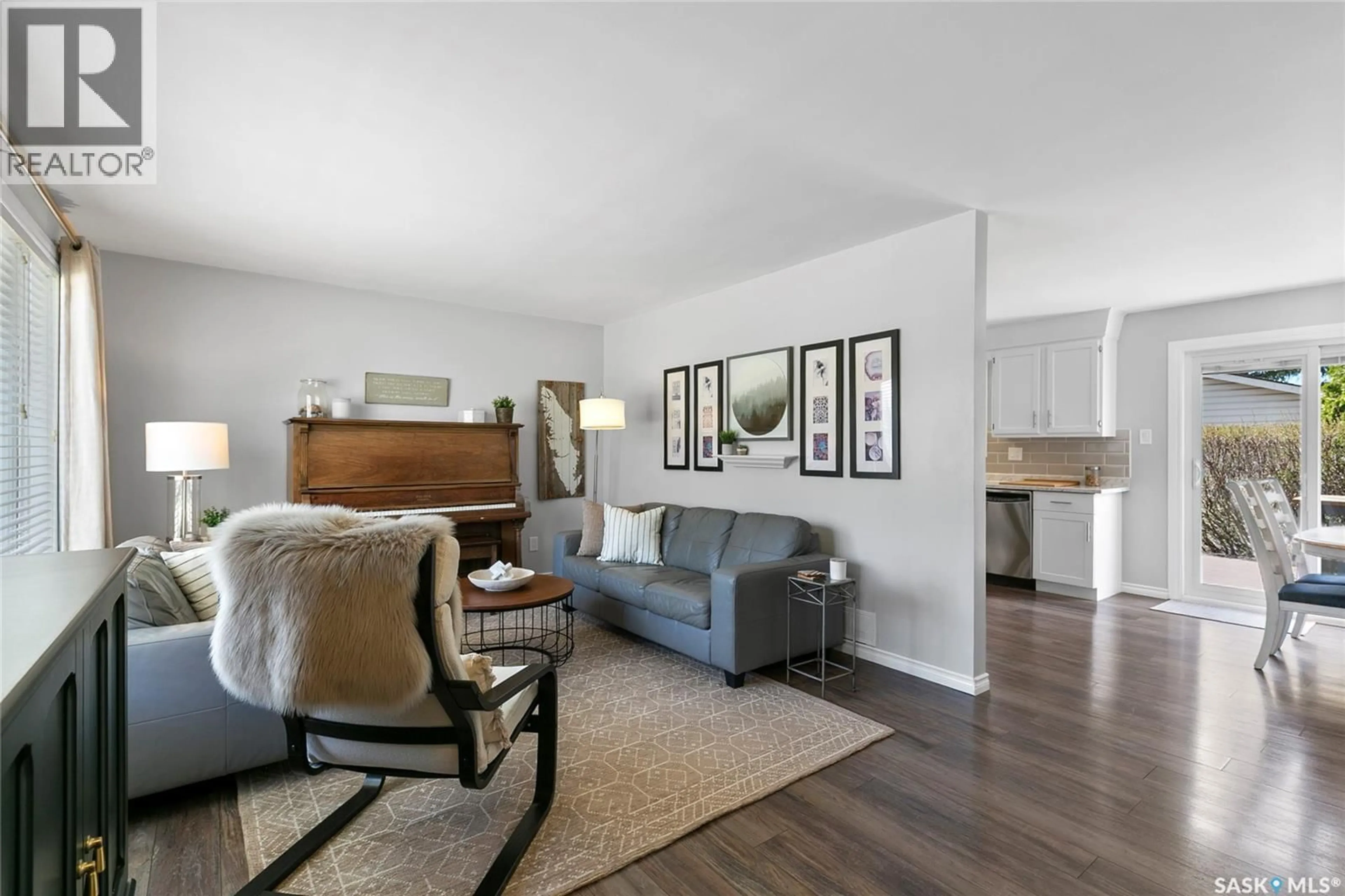 Living room with furniture, wood/laminate floor for 1206 FLEXMAN CRESCENT, Regina Saskatchewan S4X2Y8
