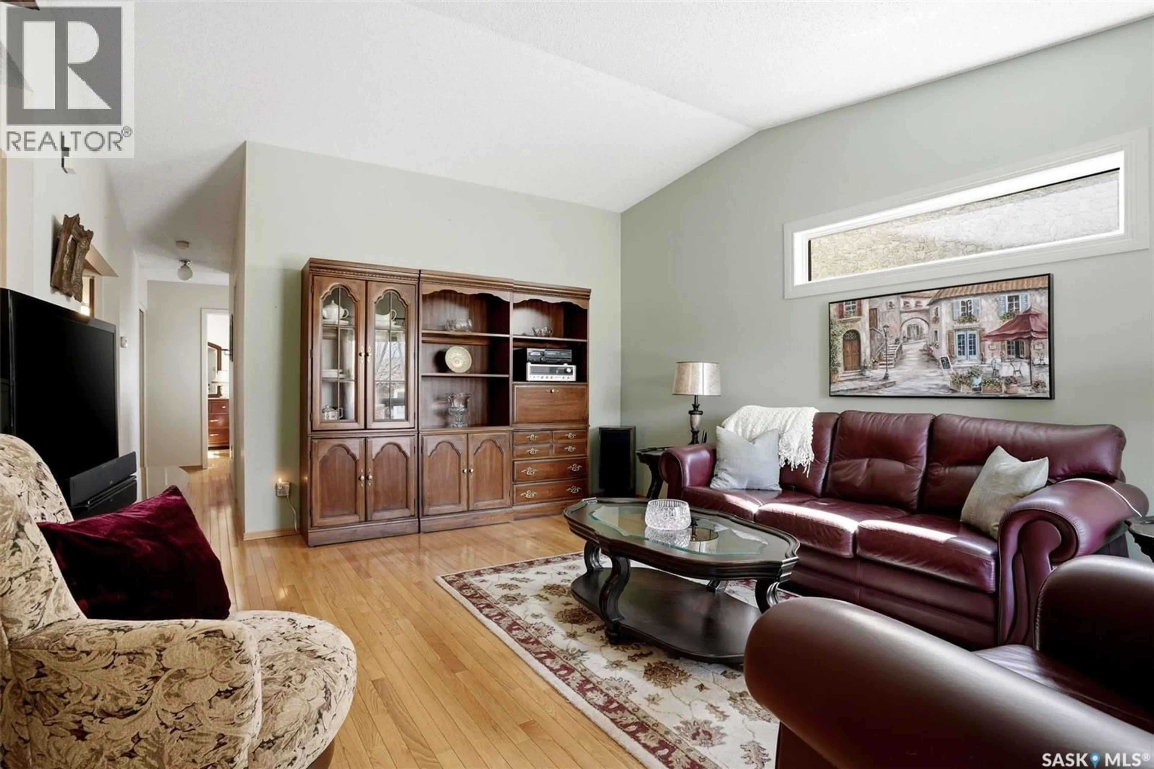 Living room with furniture, wood/laminate floor for 2750 MEADOW LANE E, Regina Saskatchewan S4V1L6