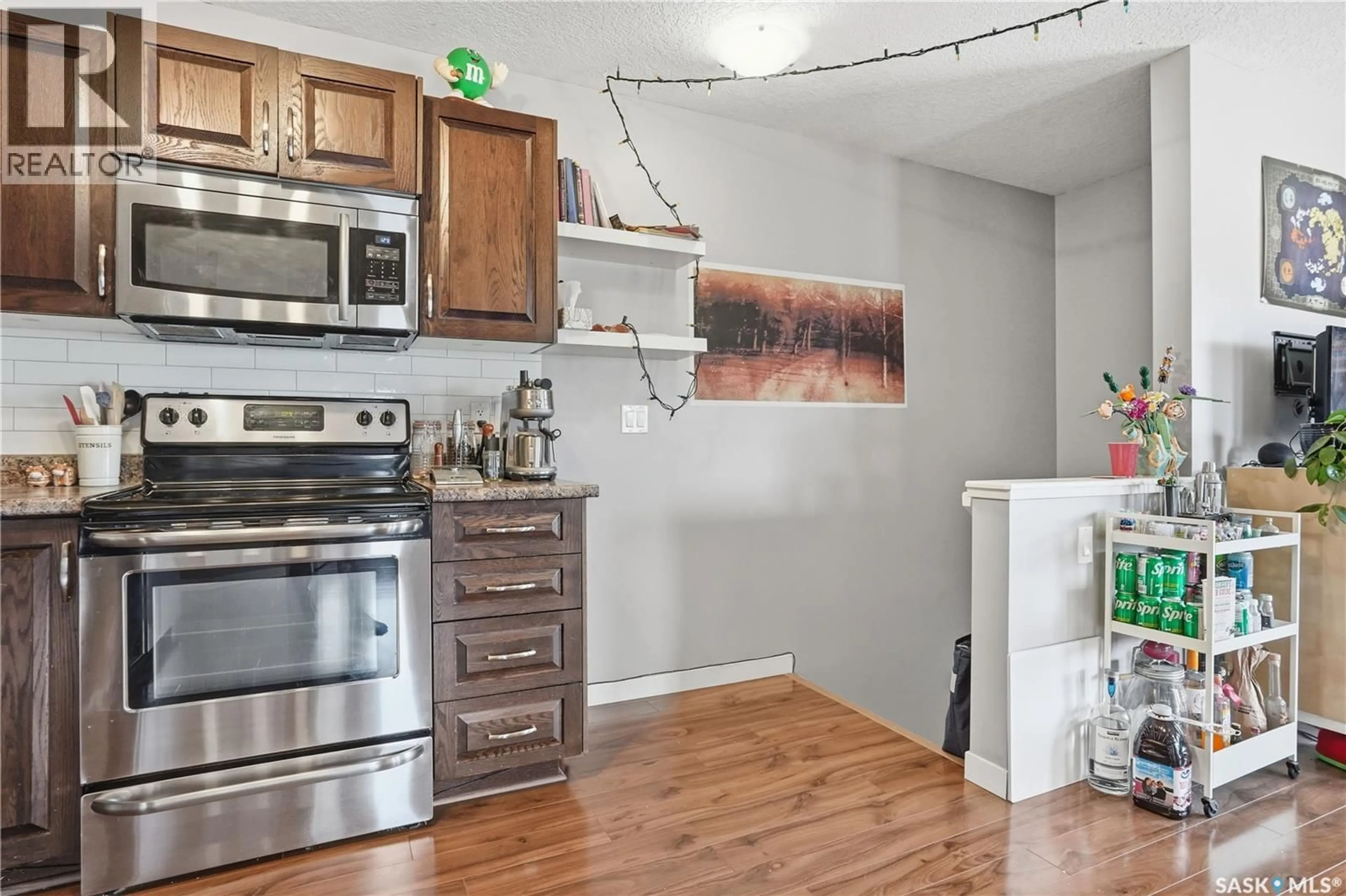 Open concept kitchen, wood/laminate floor for 114 5055 JAMES HILL ROAD, Regina Saskatchewan S4W0B9