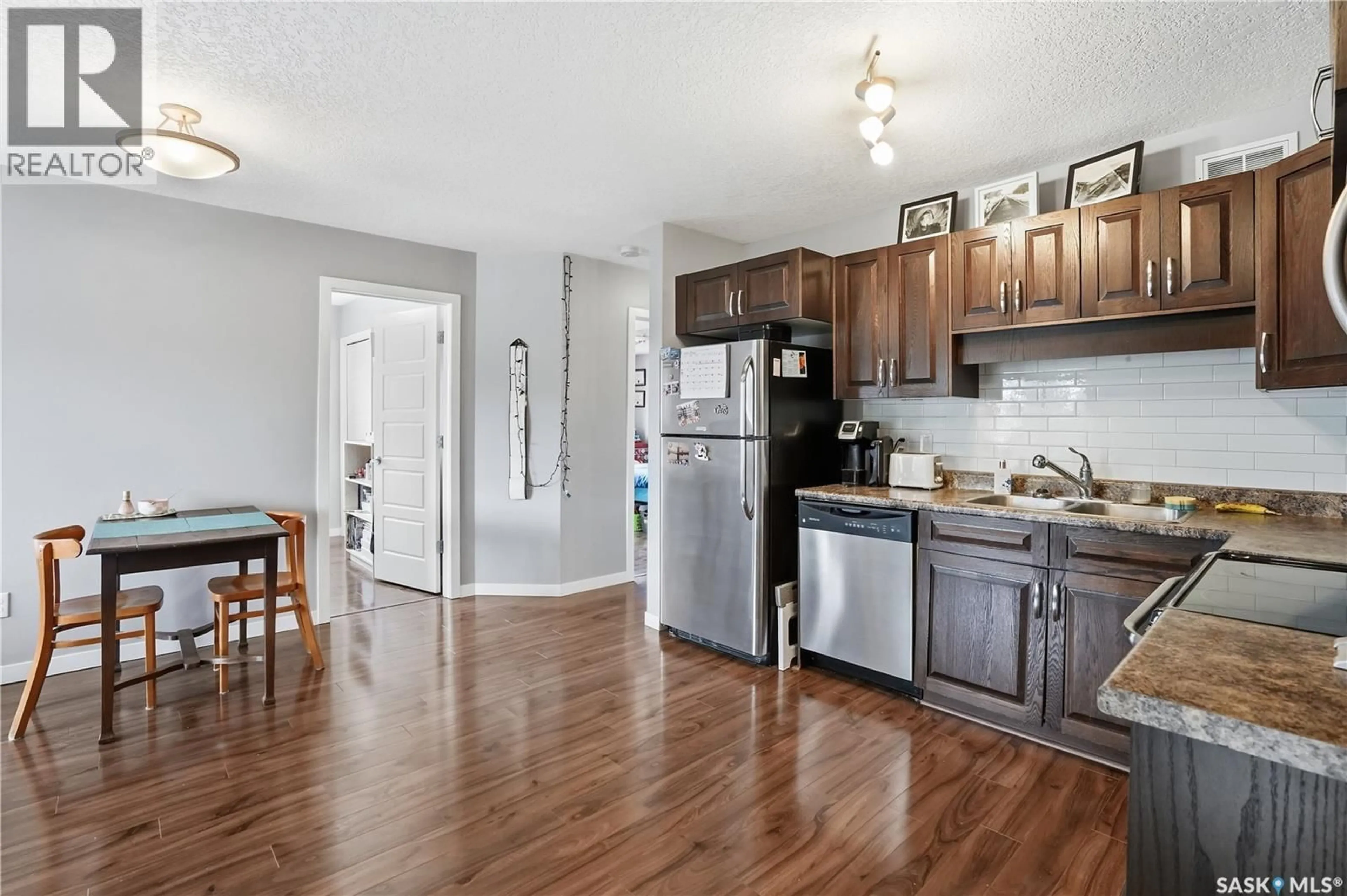 Open concept kitchen, wood/laminate floor for 114 5055 JAMES HILL ROAD, Regina Saskatchewan S4W0B9
