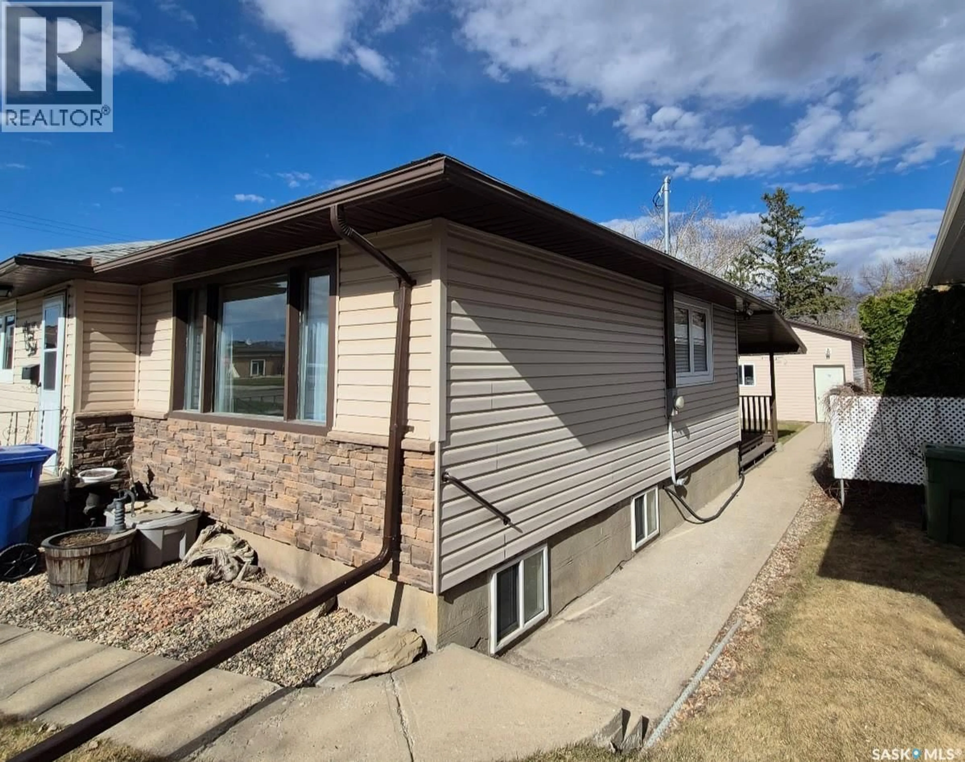 Home with vinyl exterior material, street for 203 4TH AVENUE, Yorkton Saskatchewan S3N1B7