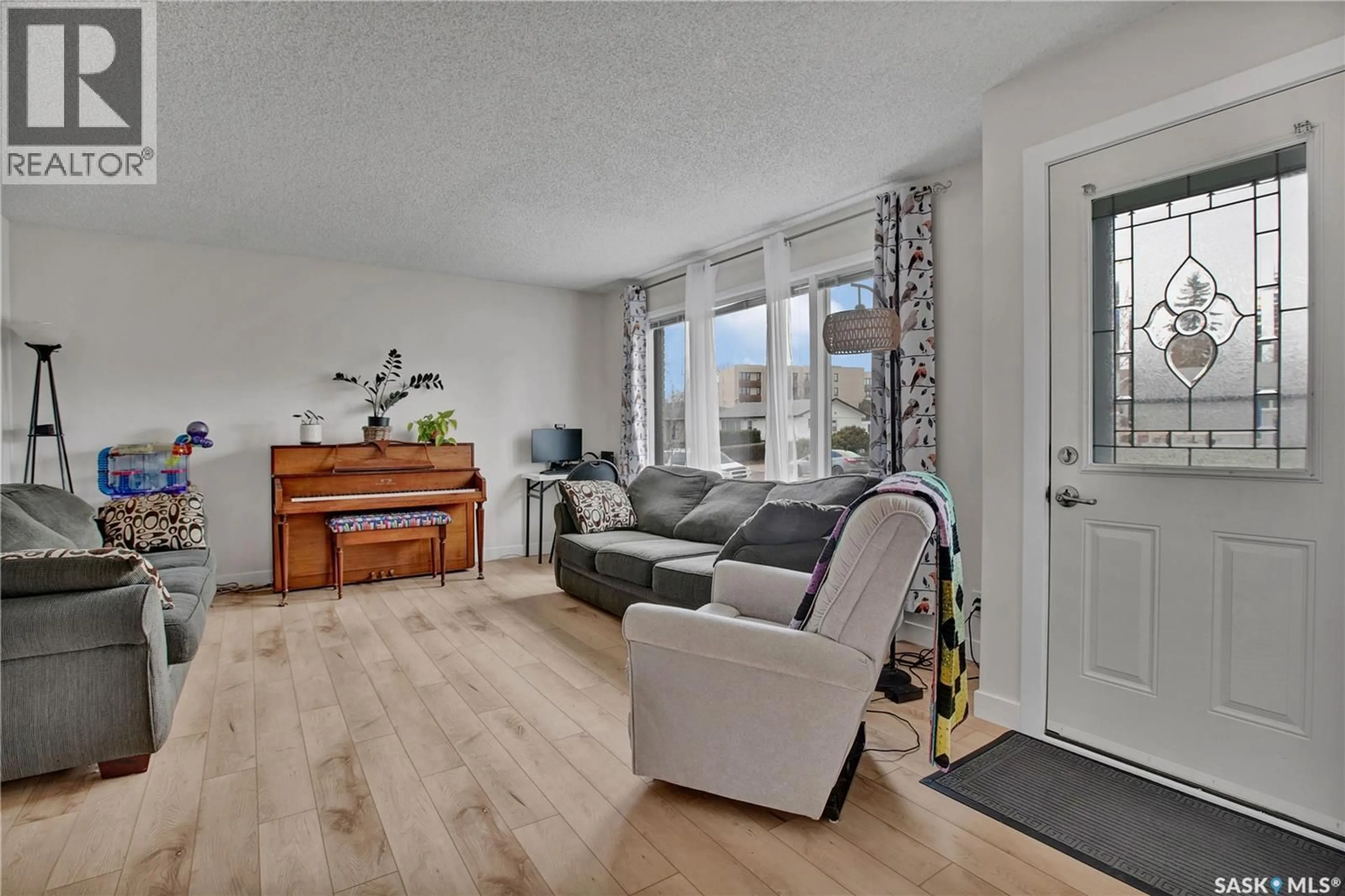 Living room with furniture, wood/laminate floor for 1104 MCMILLAN AVENUE, Saskatoon Saskatchewan S7L2V1