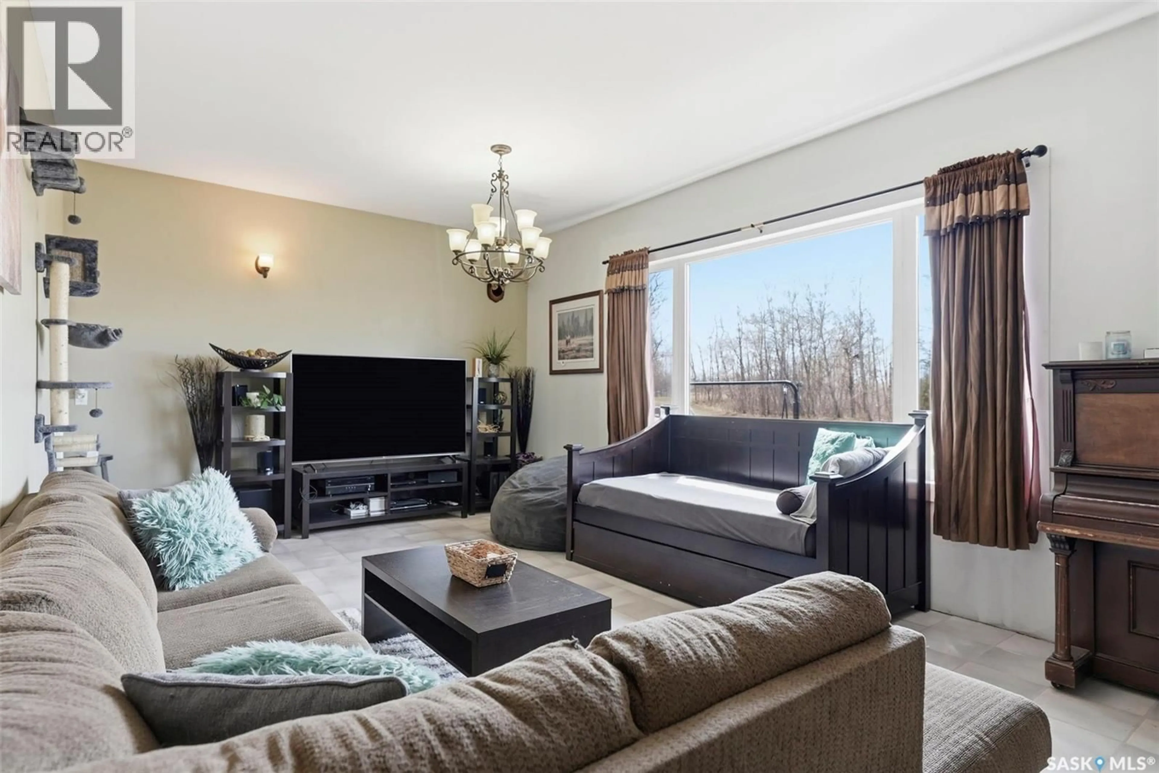 Living room with furniture, wood/laminate floor for SUNSET PRAIRIE ACREAGE, Prince Albert Rm No. 461 Saskatchewan S0K2S0
