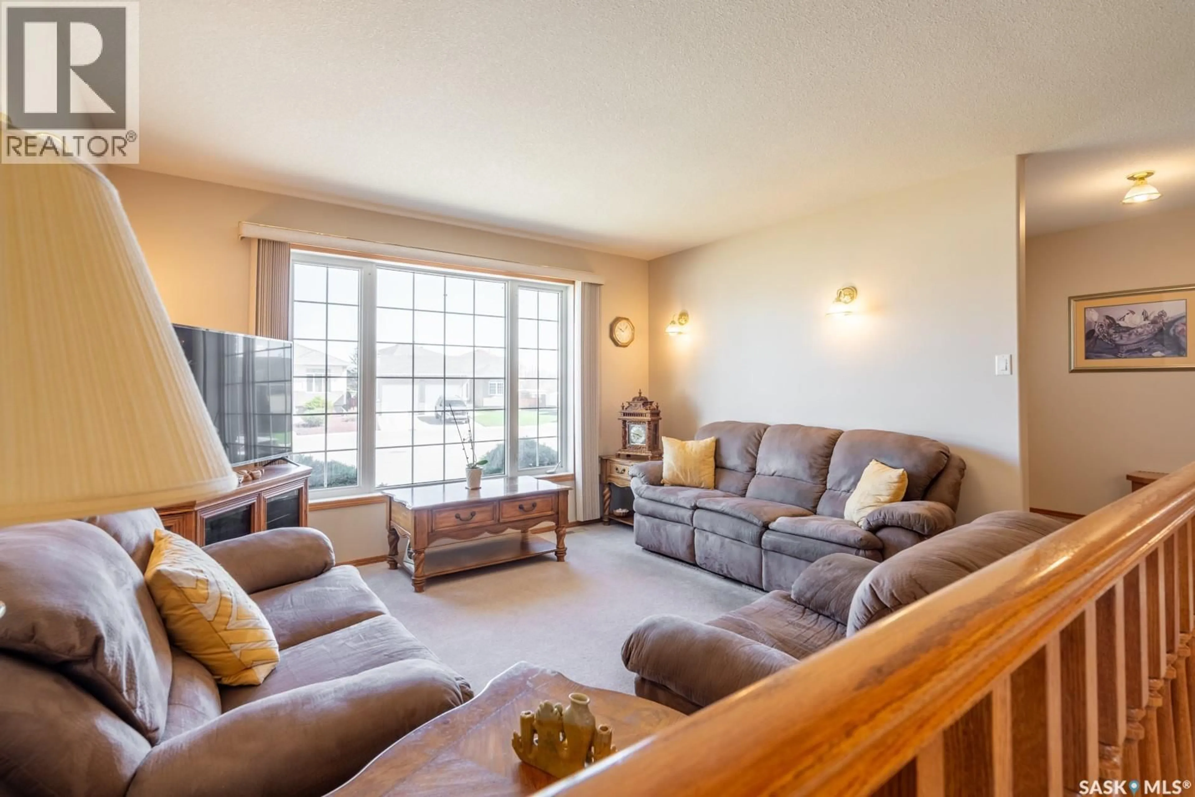 Living room with furniture, wood/laminate floor for 2346 MCGREGOR PLACE, Regina Saskatchewan S4V2Y4