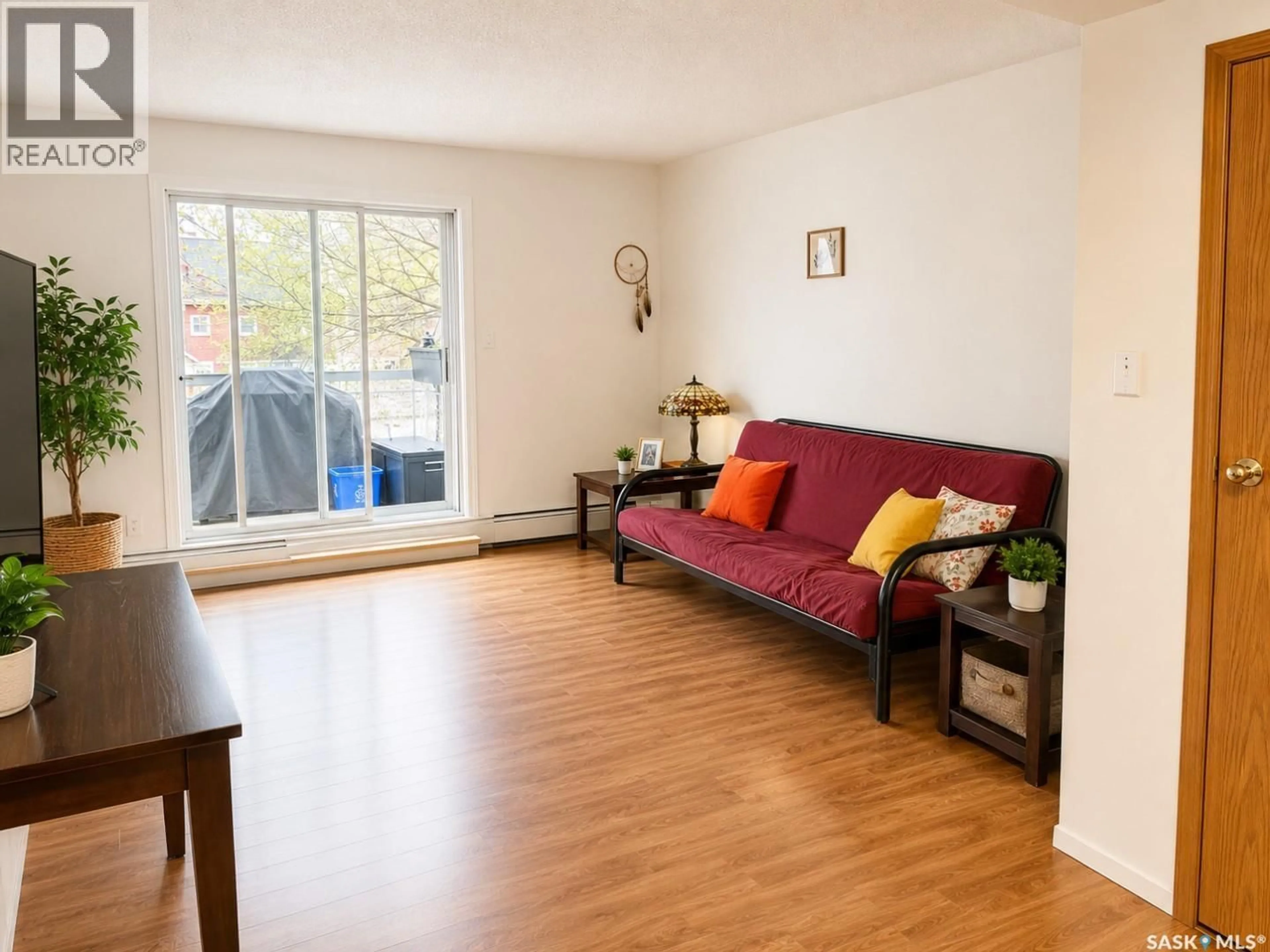 Living room with furniture, wood/laminate floor for 102 - 419 MAIN STREET, Saskatoon Saskatchewan S7N0B9