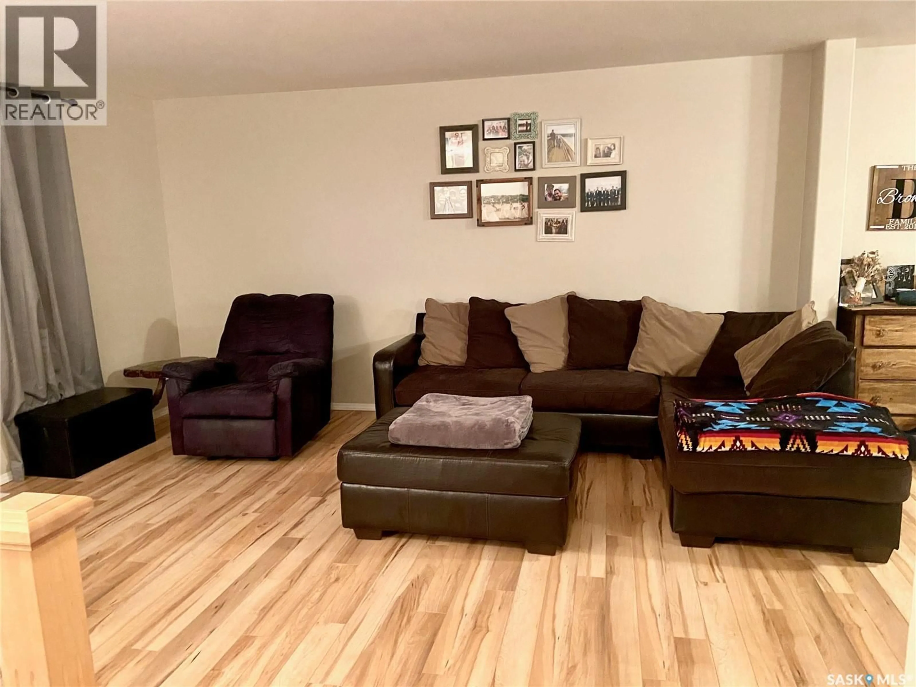 Living room with furniture, wood/laminate floor for 19 200 HIEBERT CRESCENT, Martensville Saskatchewan S0K2T2