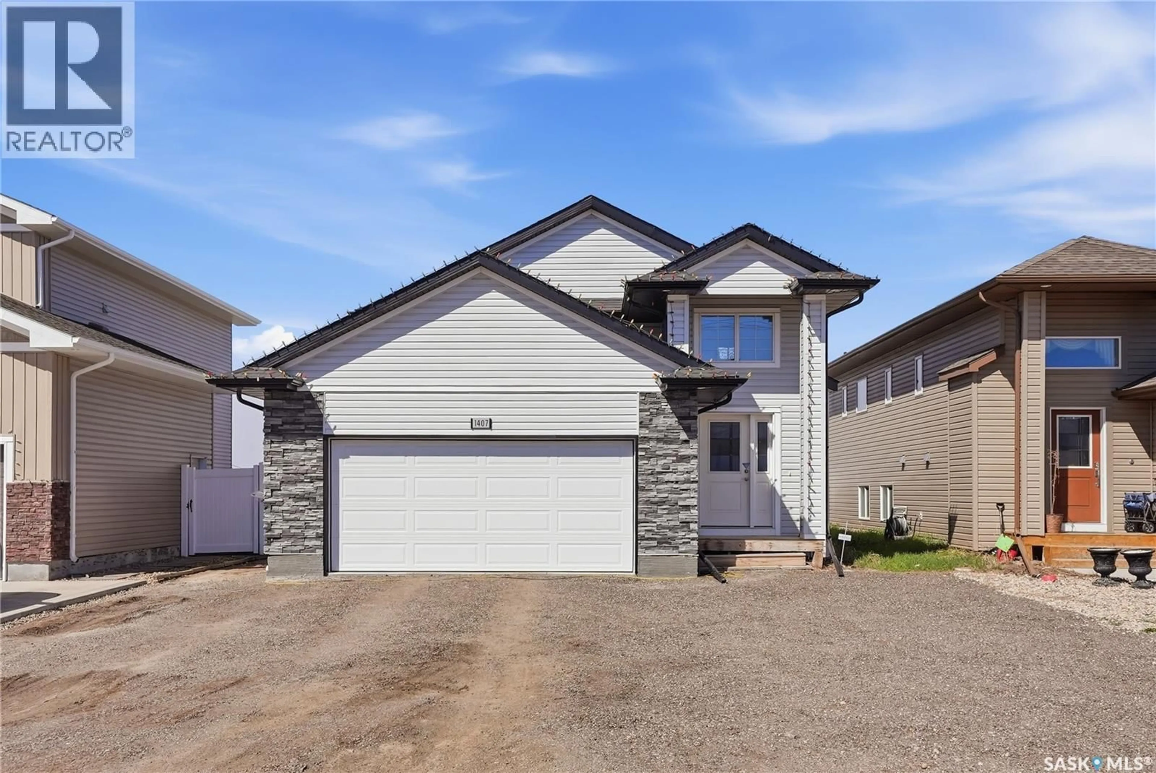 Home with vinyl exterior material, street for 1407 HUGHES DRIVE, Saskatoon Saskatchewan S7L7N2
