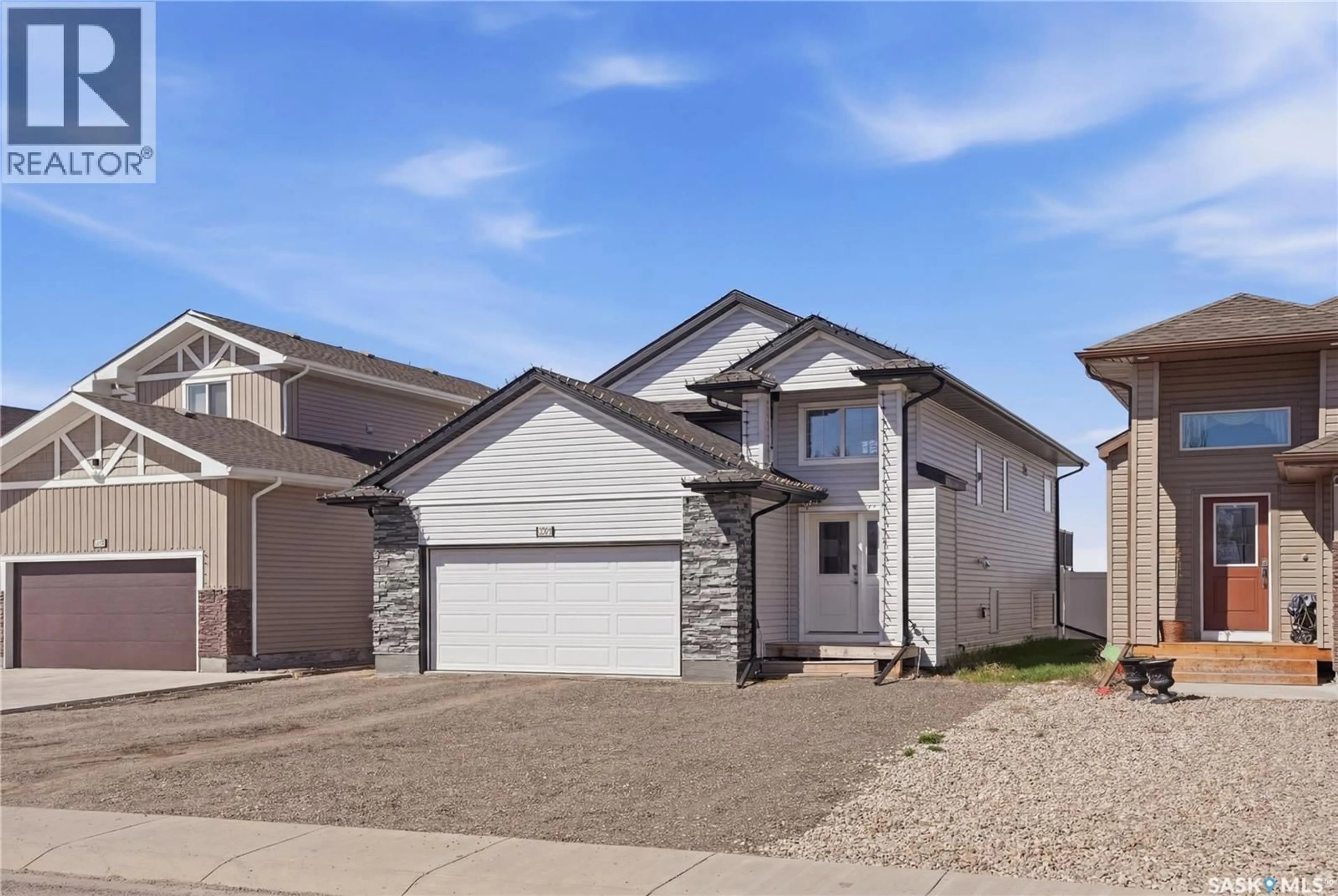 Home with vinyl exterior material, street for 1407 HUGHES DRIVE, Saskatoon Saskatchewan S7L7N2