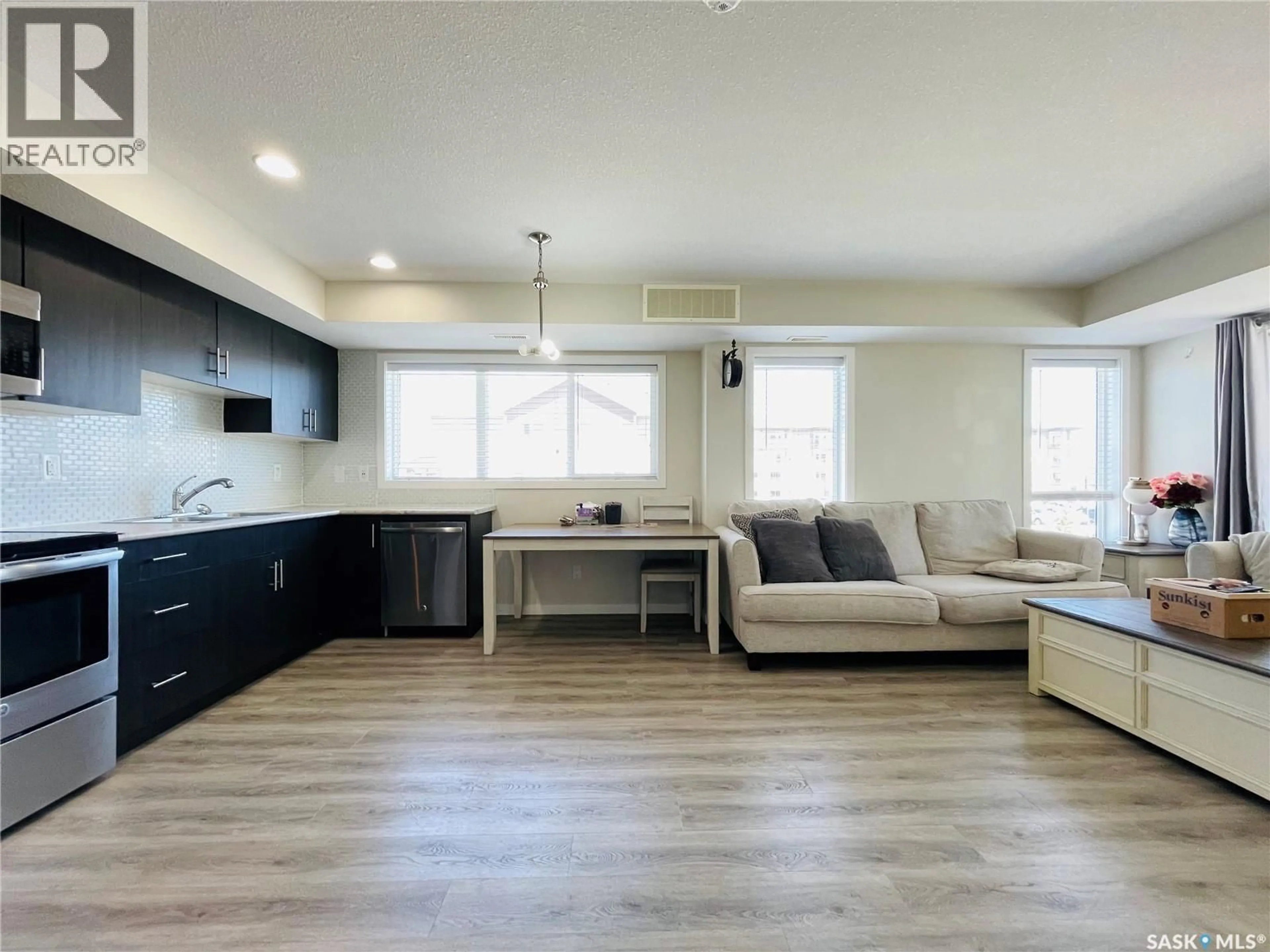 Open concept kitchen, wood/laminate floor for 104 - 3367 GREEN POPPY STREET, Regina Saskatchewan S4V3P6