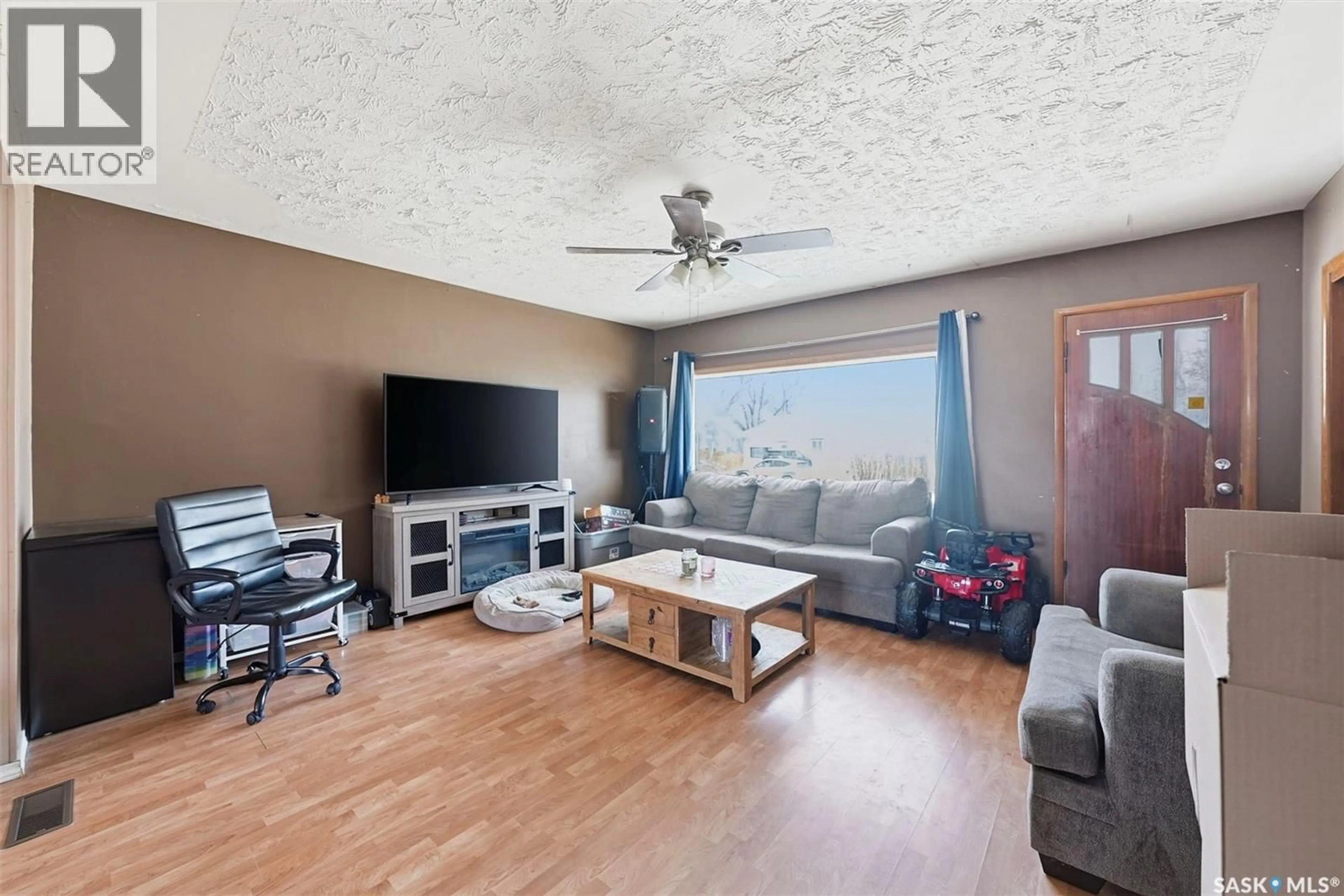 Living room with furniture, wood/laminate floor for 439 22ND STREET, Prince Albert Saskatchewan S6V1V5