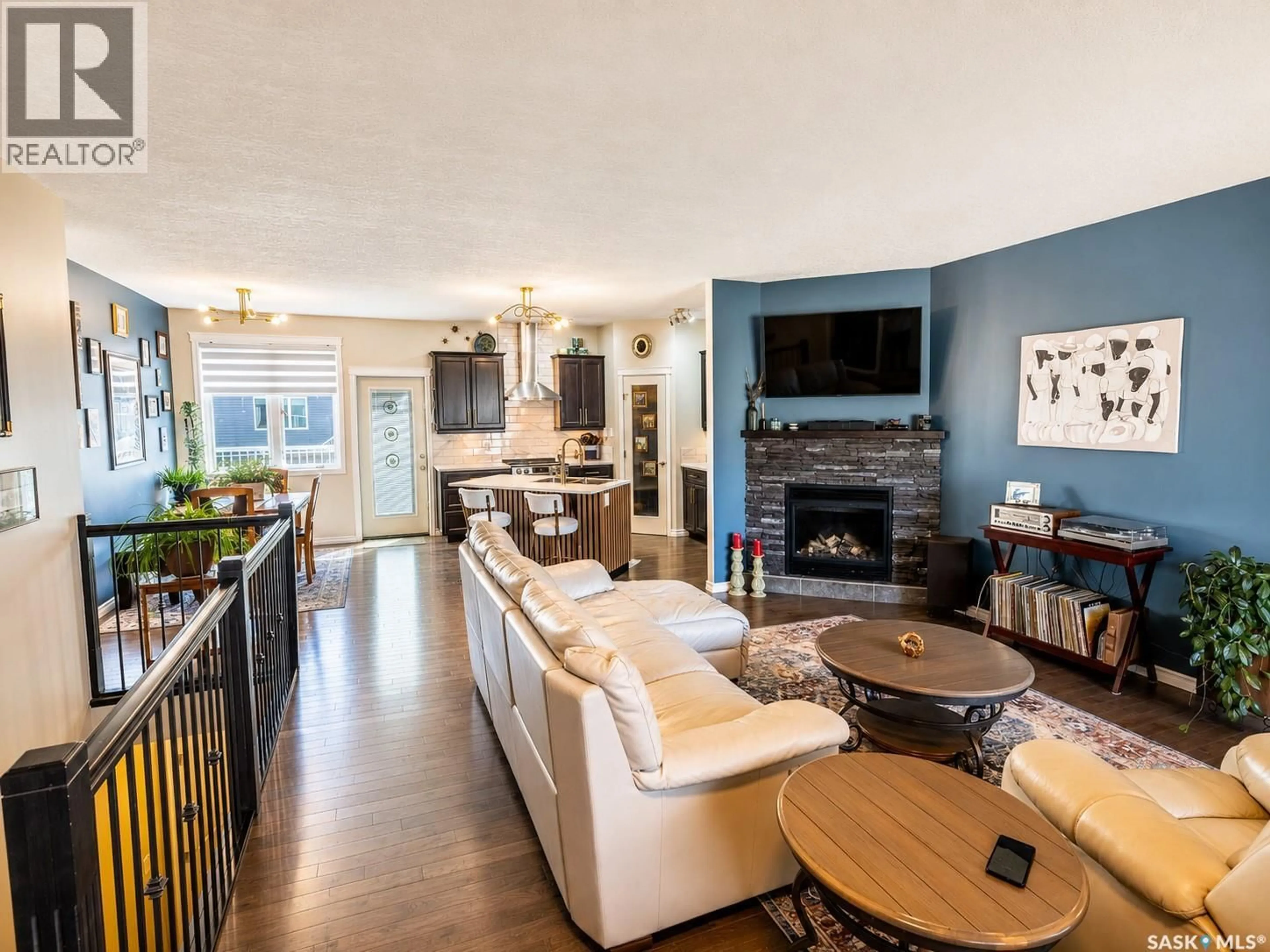 Living room with furniture, wood/laminate floor for 148 WELLINGTON DRIVE, Moose Jaw Saskatchewan S6K0A6