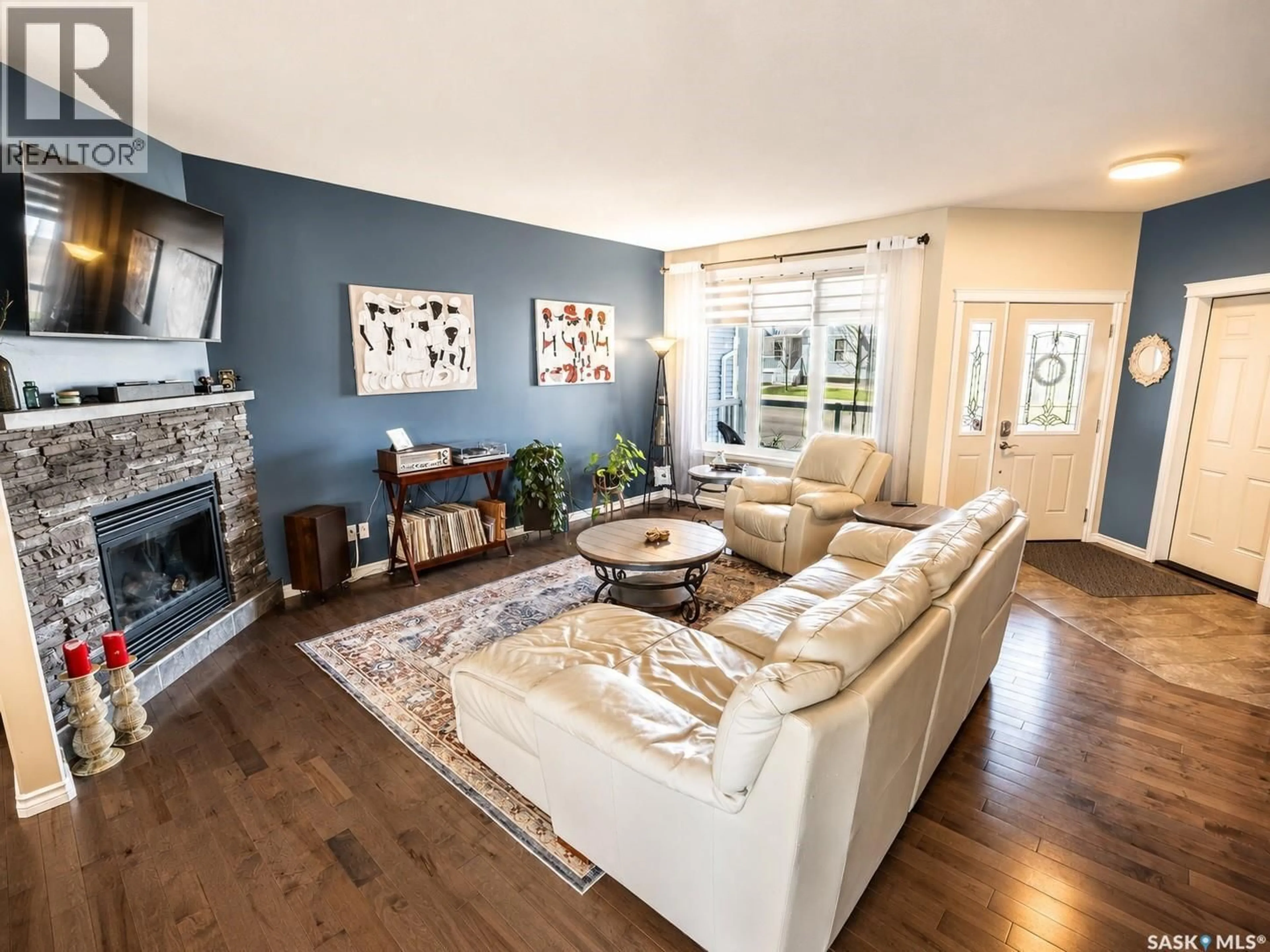 Living room with furniture, wood/laminate floor for 148 WELLINGTON DRIVE, Moose Jaw Saskatchewan S6K0A6
