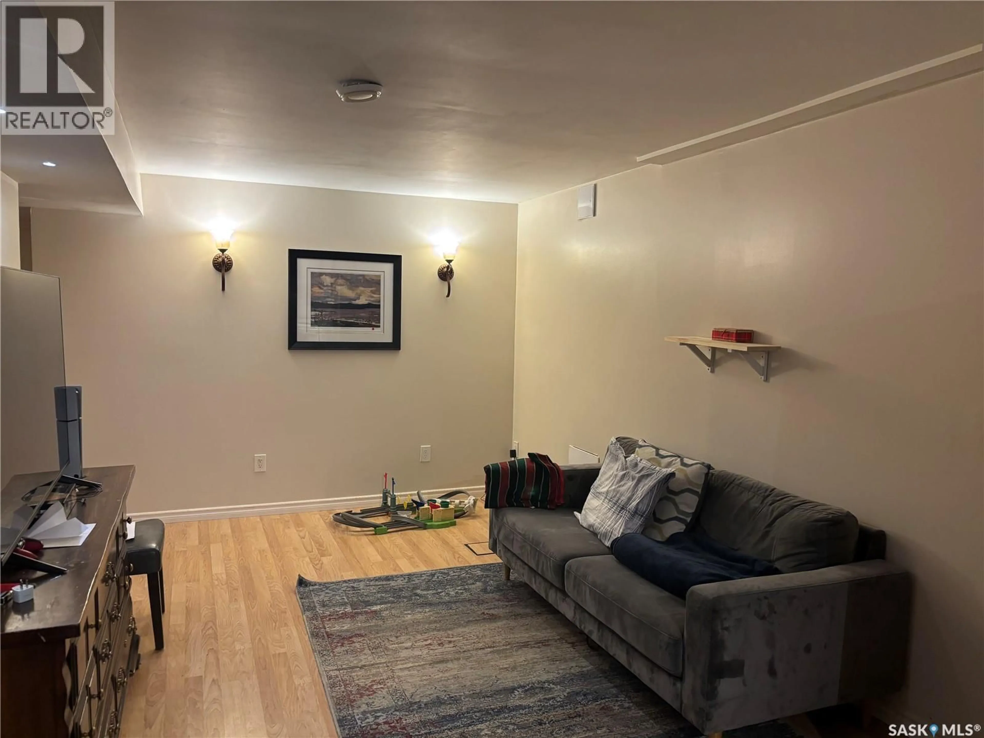 Living room with furniture, wood/laminate floor for 1113 WILSON CRESCENT, Saskatoon Saskatchewan S7J2M7