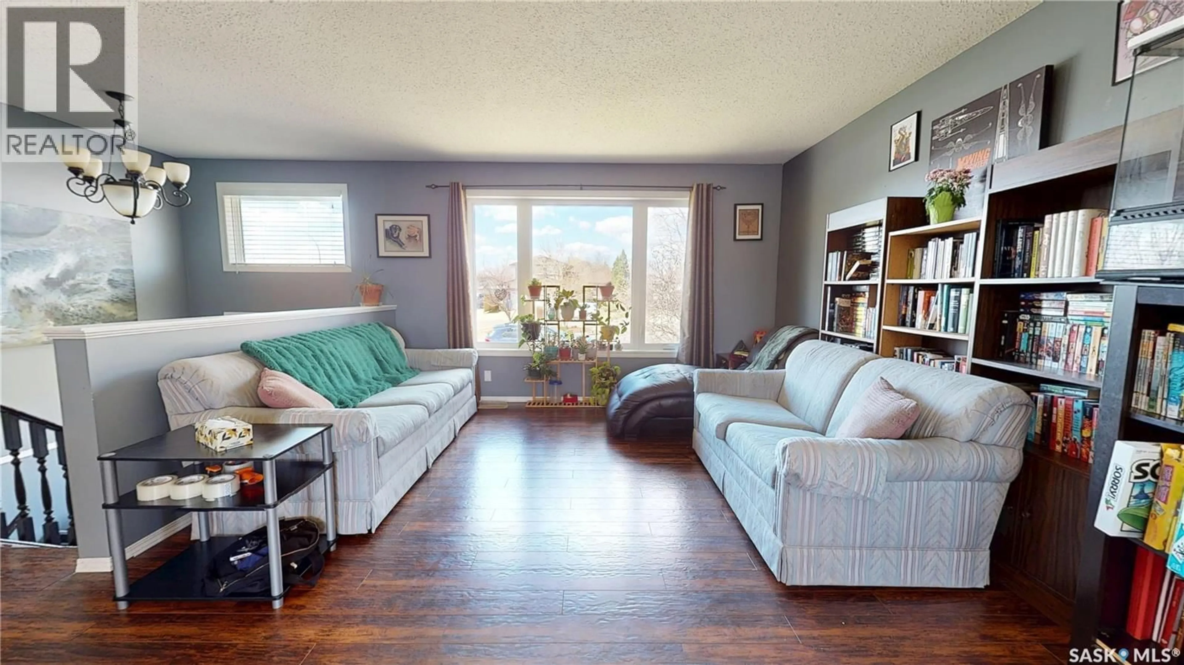 Living room with furniture, wood/laminate floor for 1126 BRETT BAY, Regina Saskatchewan S4N6N7