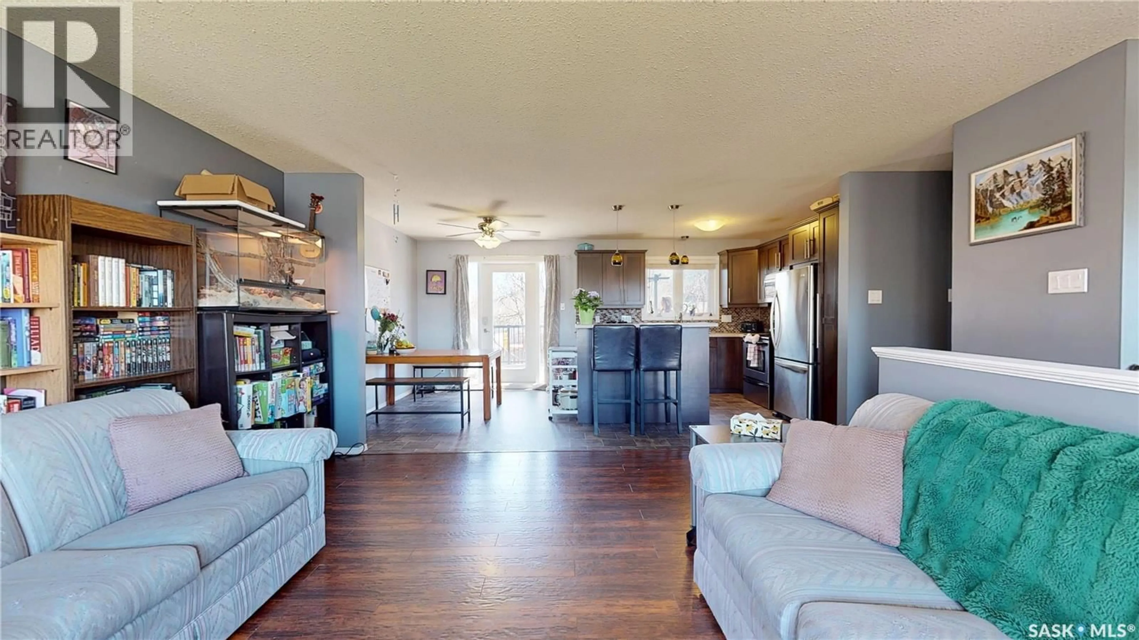 Living room with furniture, wood/laminate floor for 1126 BRETT BAY, Regina Saskatchewan S4N6N7