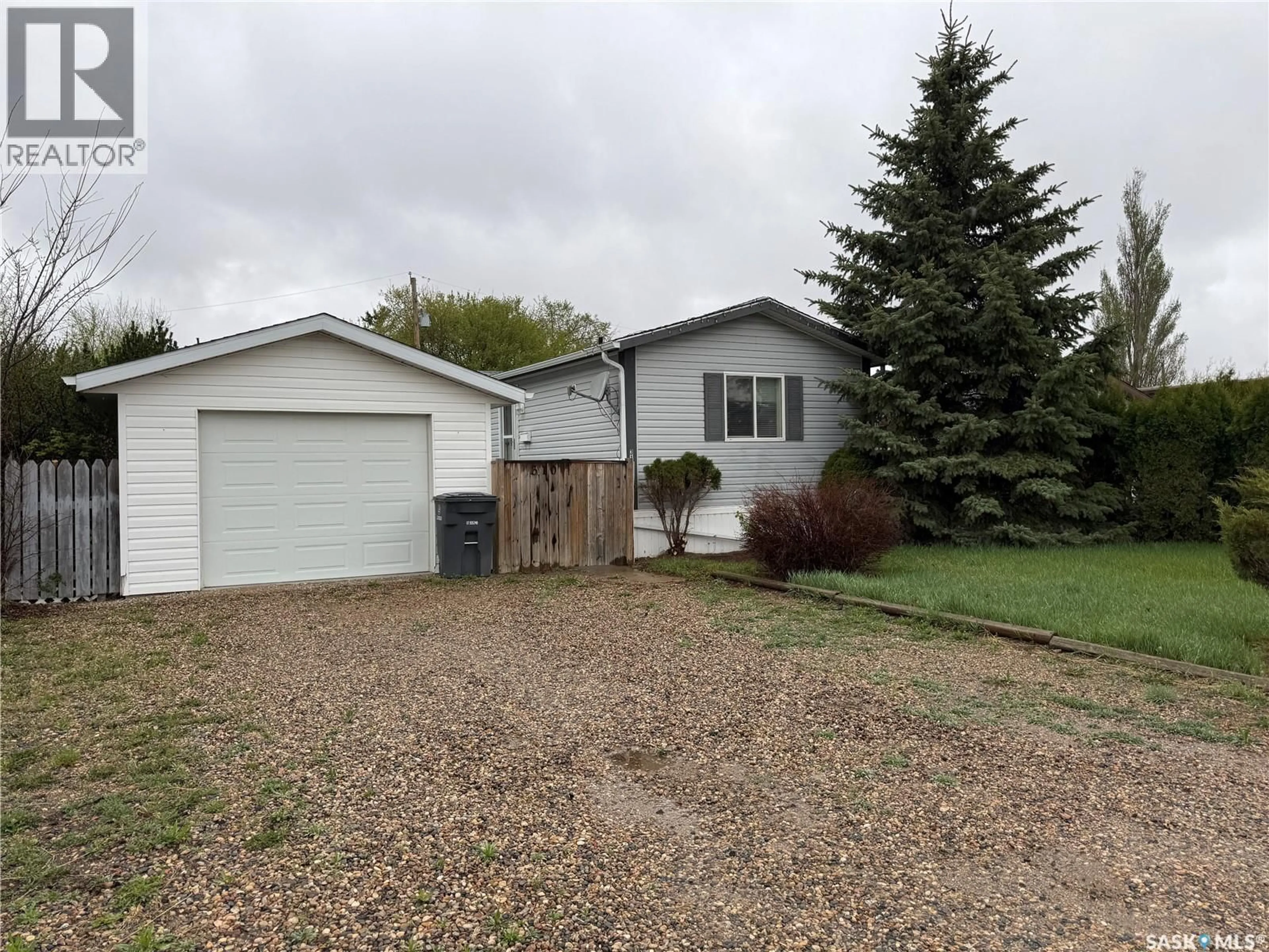 Home with vinyl exterior material, street for 310 CHRISTIE STREET, Outlook Saskatchewan S0L2N0