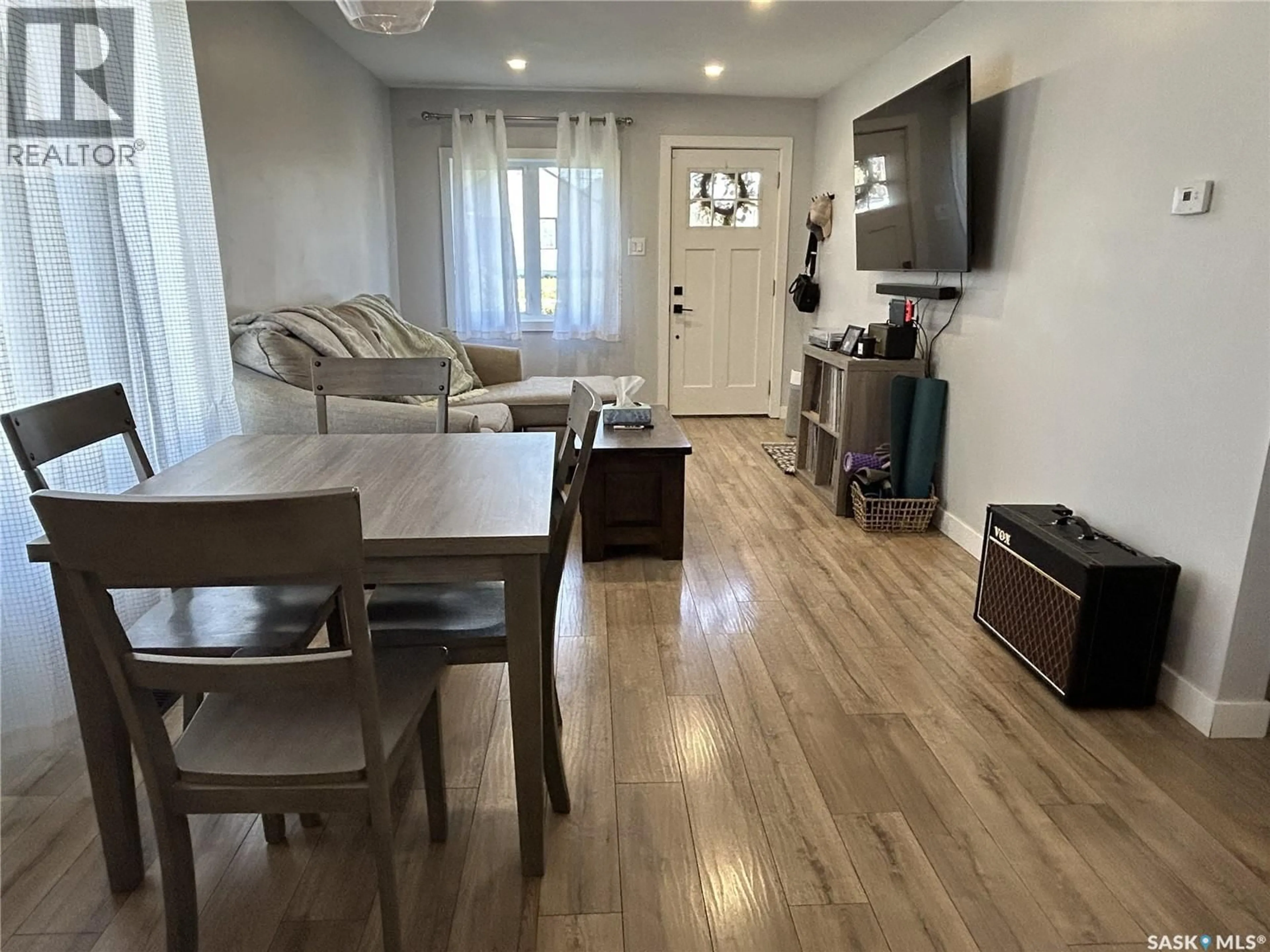 Living room with furniture, wood/laminate floor for 810 1ST STREET, Estevan Saskatchewan S4A0G3
