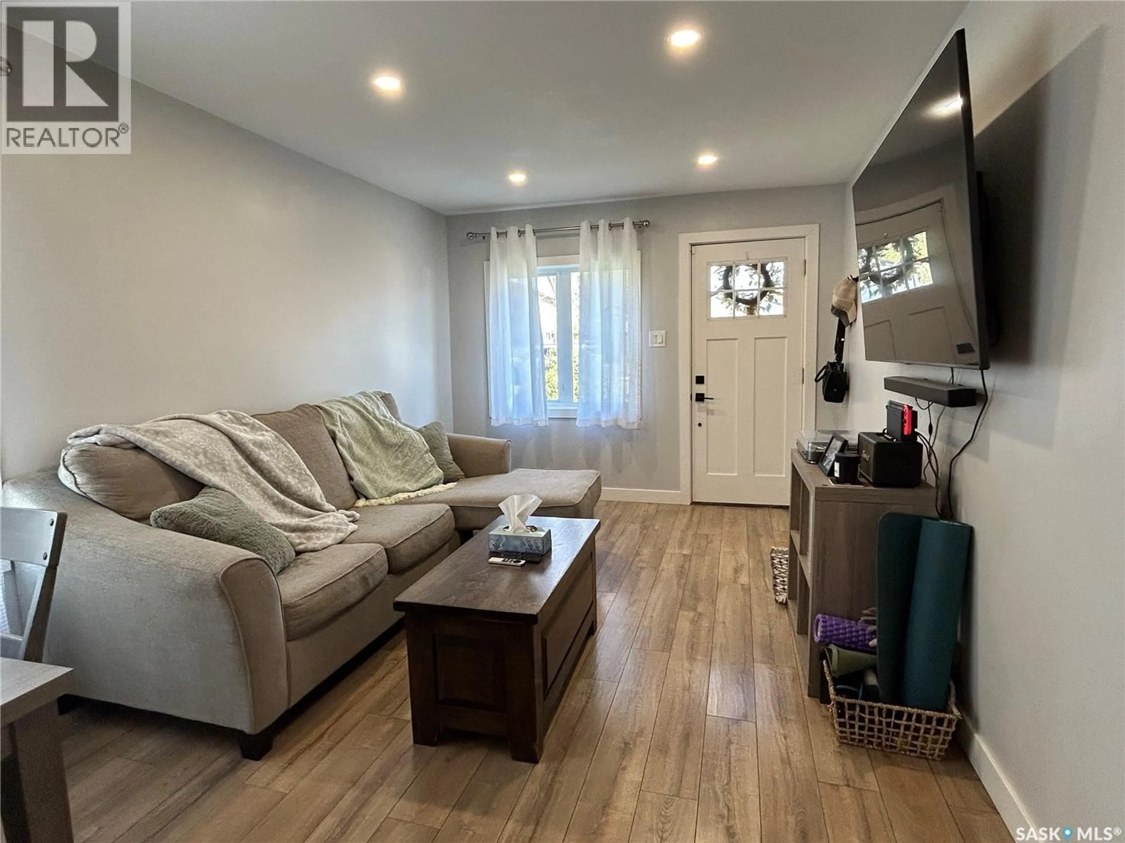 Living room with furniture, wood/laminate floor for 810 1ST STREET, Estevan Saskatchewan S4A0G3