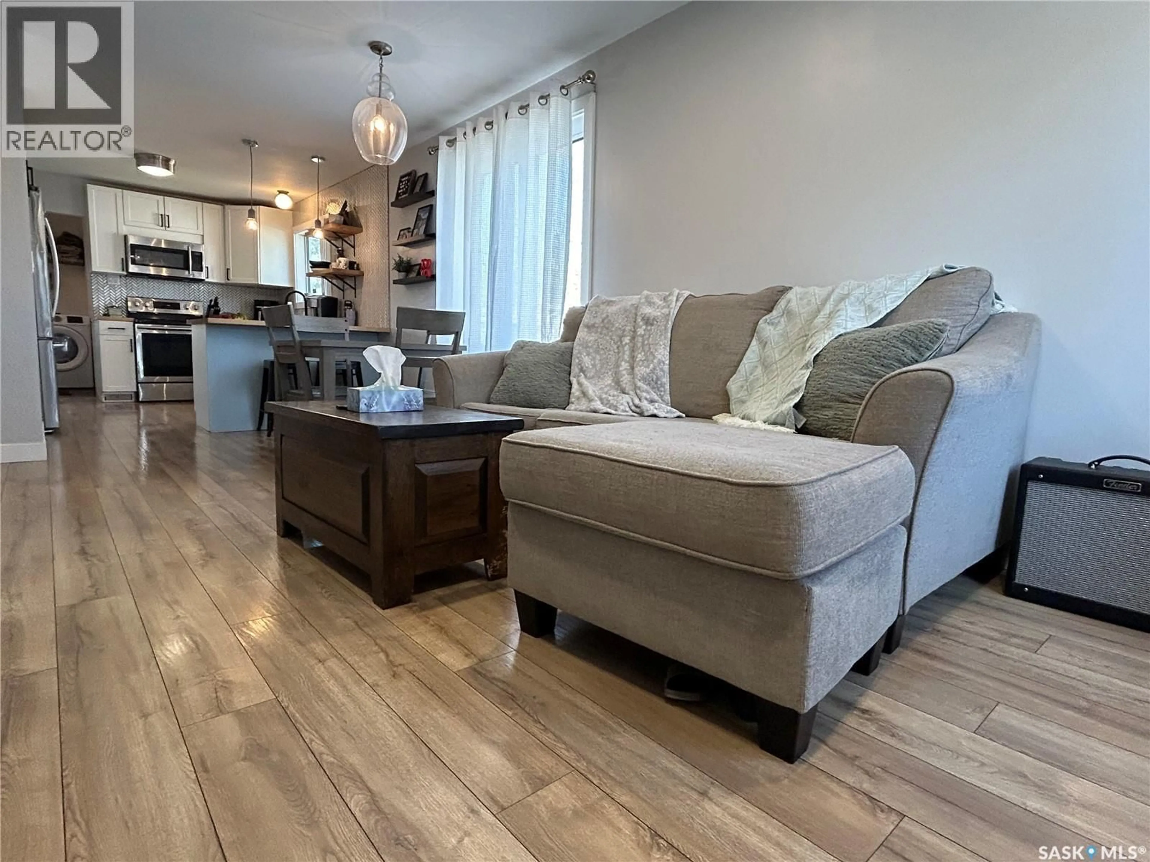 Living room with furniture, wood/laminate floor for 810 1ST STREET, Estevan Saskatchewan S4A0G3