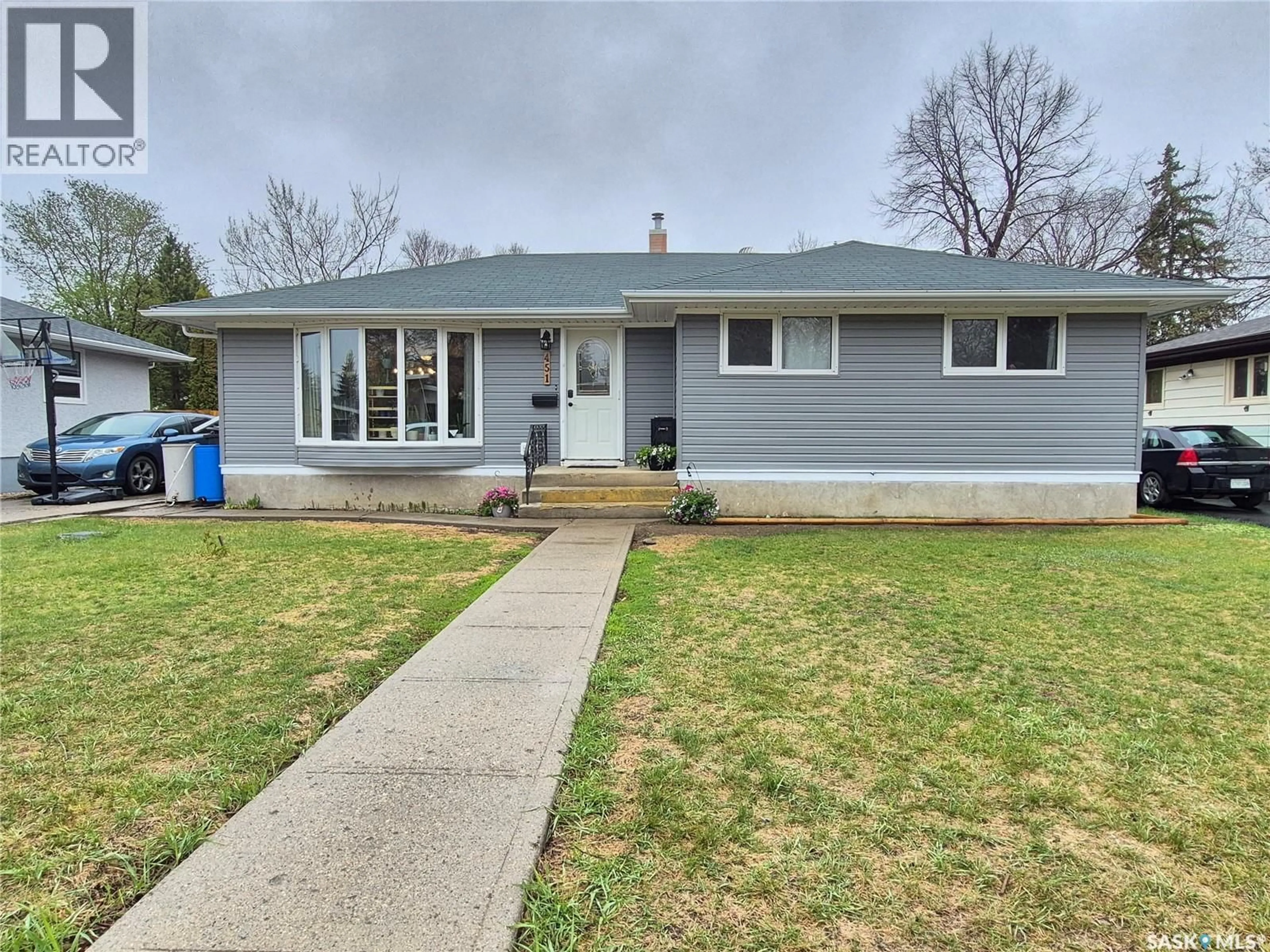 Home with vinyl exterior material, street for 451 WOODLAWN CRESCENT, Weyburn Saskatchewan S4H0X5