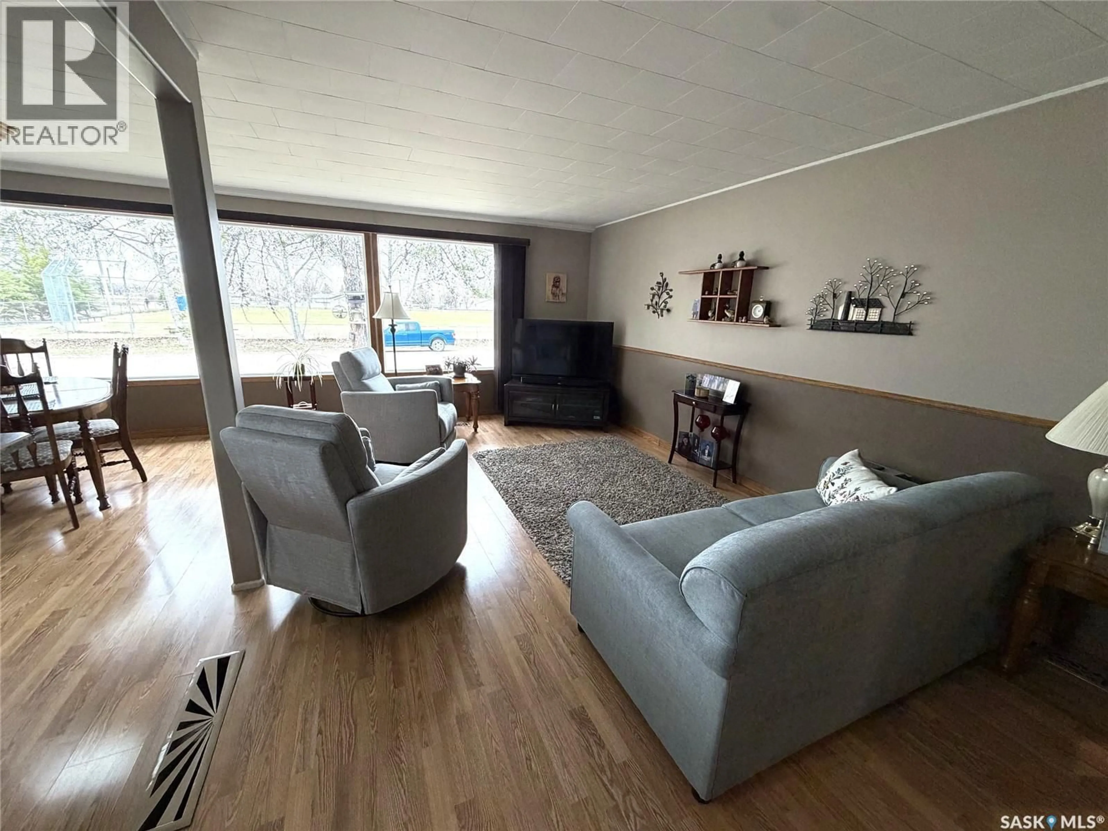 Living room with furniture, wood/laminate floor for 724 PRINCE STREET, Hudson Bay Saskatchewan S0E0Y0