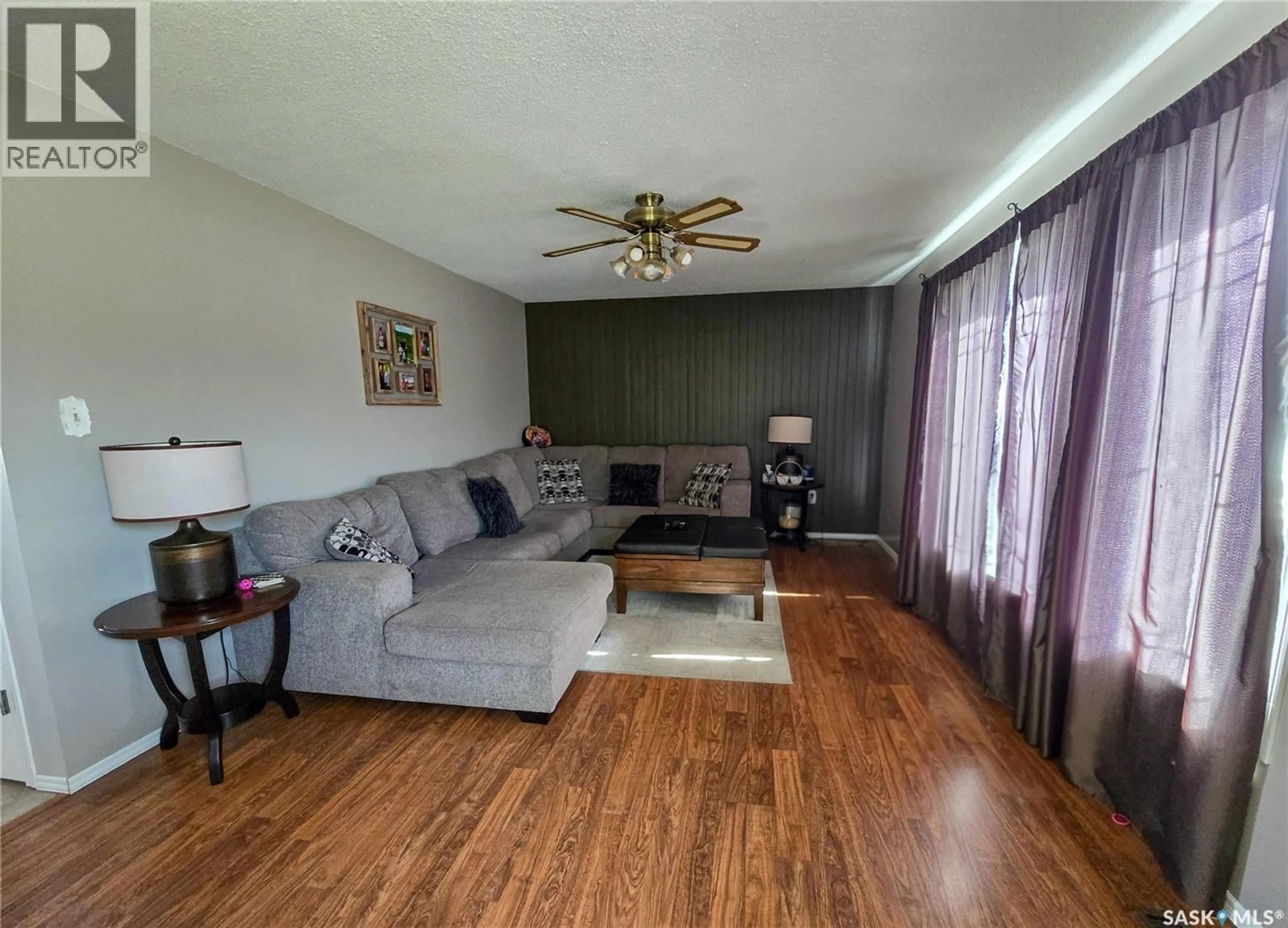 Living room with furniture, wood/laminate floor for 15 MACKENZIE DRIVE, Yorkton Saskatchewan S3N3M6