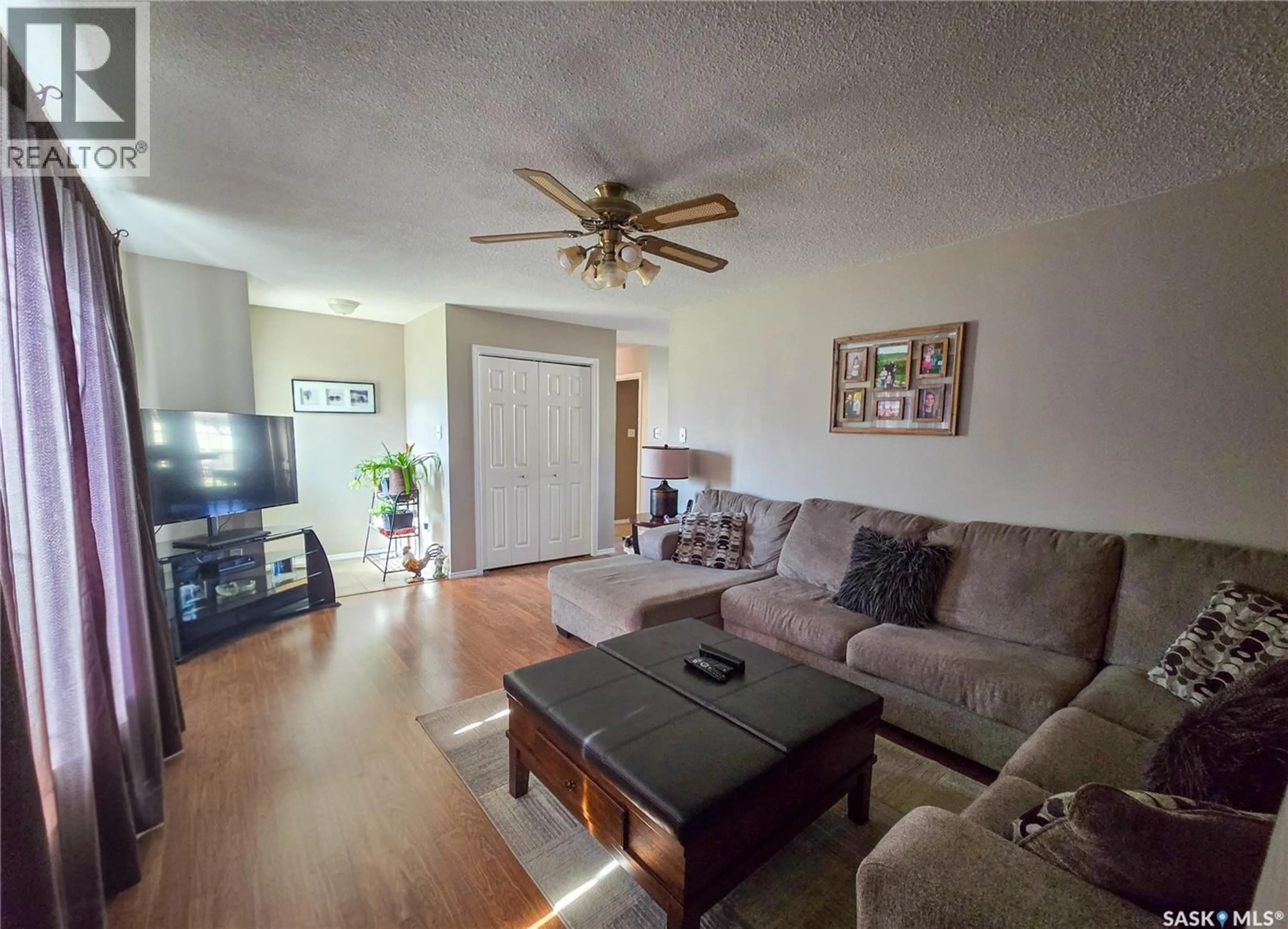 Living room with furniture, wood/laminate floor for 15 MACKENZIE DRIVE, Yorkton Saskatchewan S3N3M6