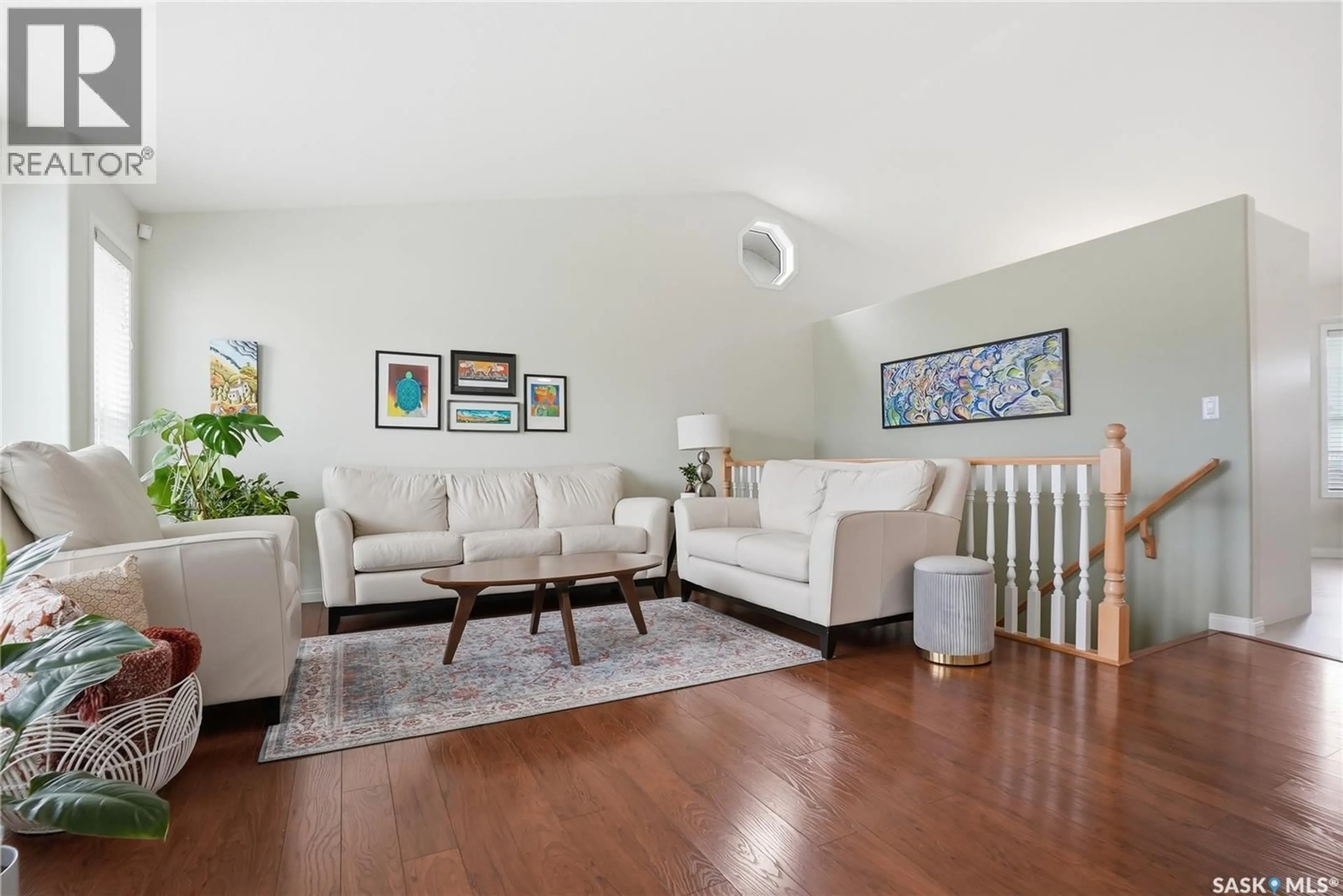 Living room with furniture, wood/laminate floor for 223 POBRAN LANE, Saskatoon Saskatchewan S7S1L5