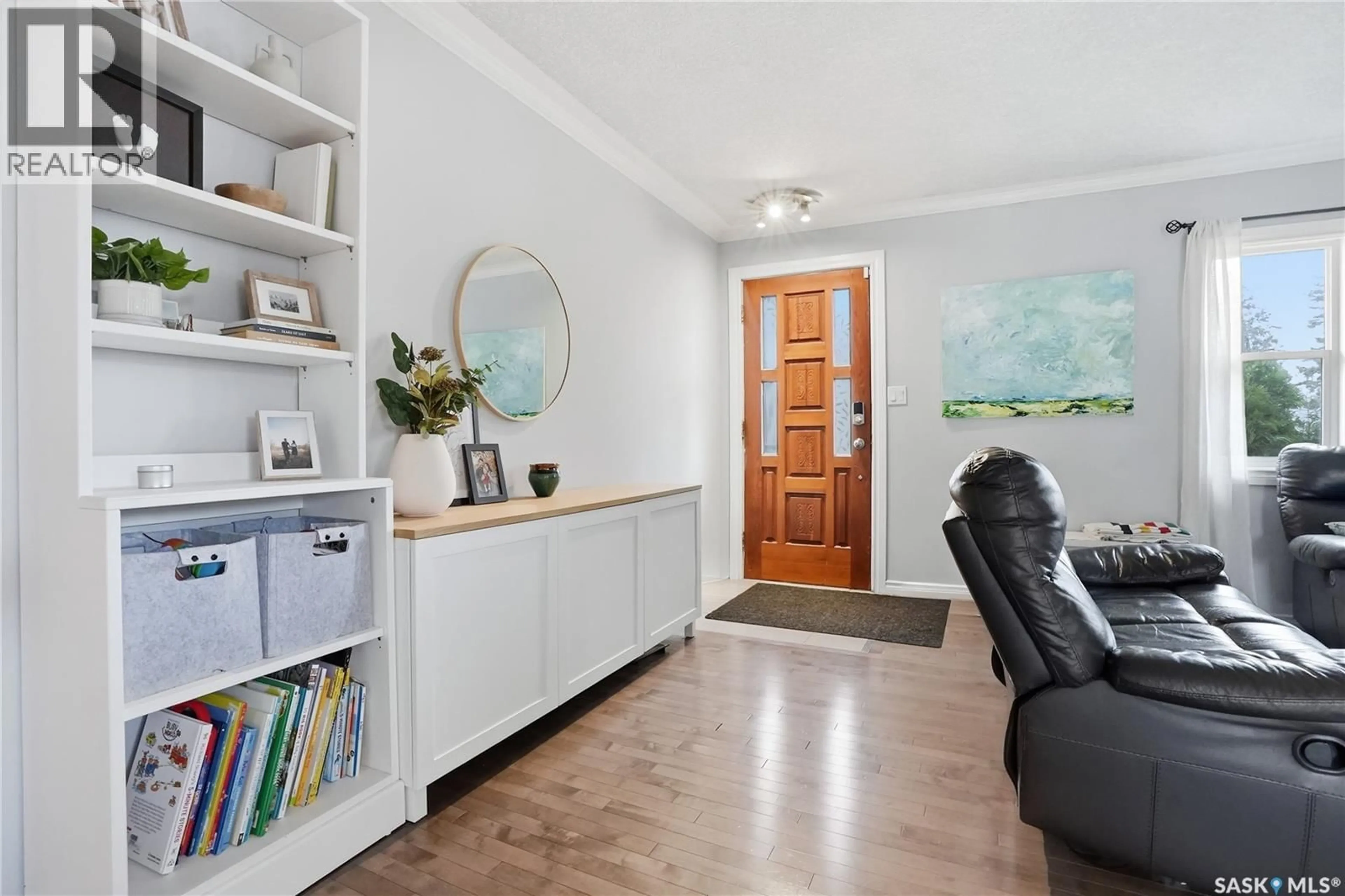 Living room with furniture, wood/laminate floor for 1210 K AVENUE, Saskatoon Saskatchewan S7L2N9