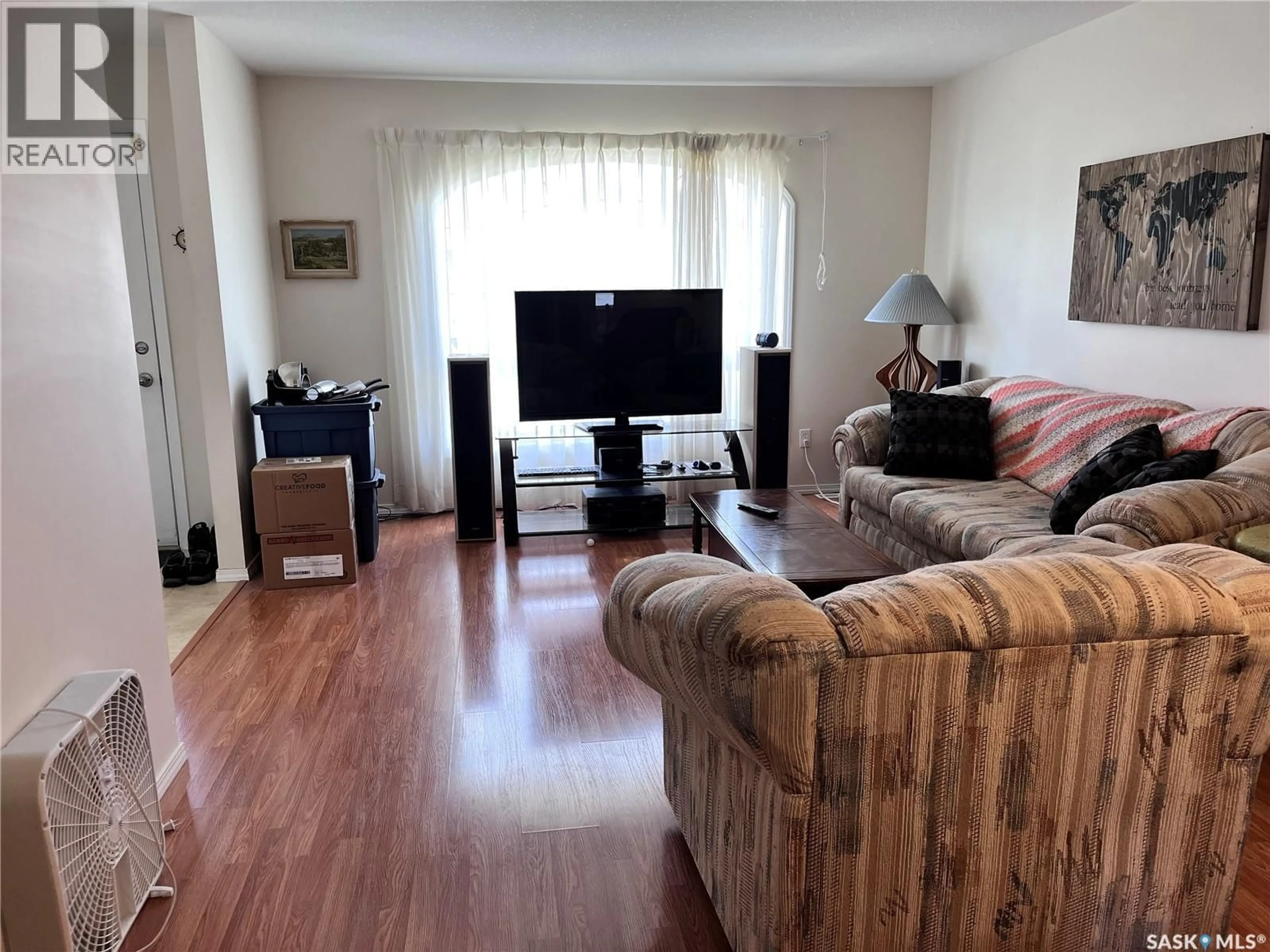 Living room with furniture, wood/laminate floor for W - 3 119 MCKENDRY AVENUE, Melfort Saskatchewan S0E1A0