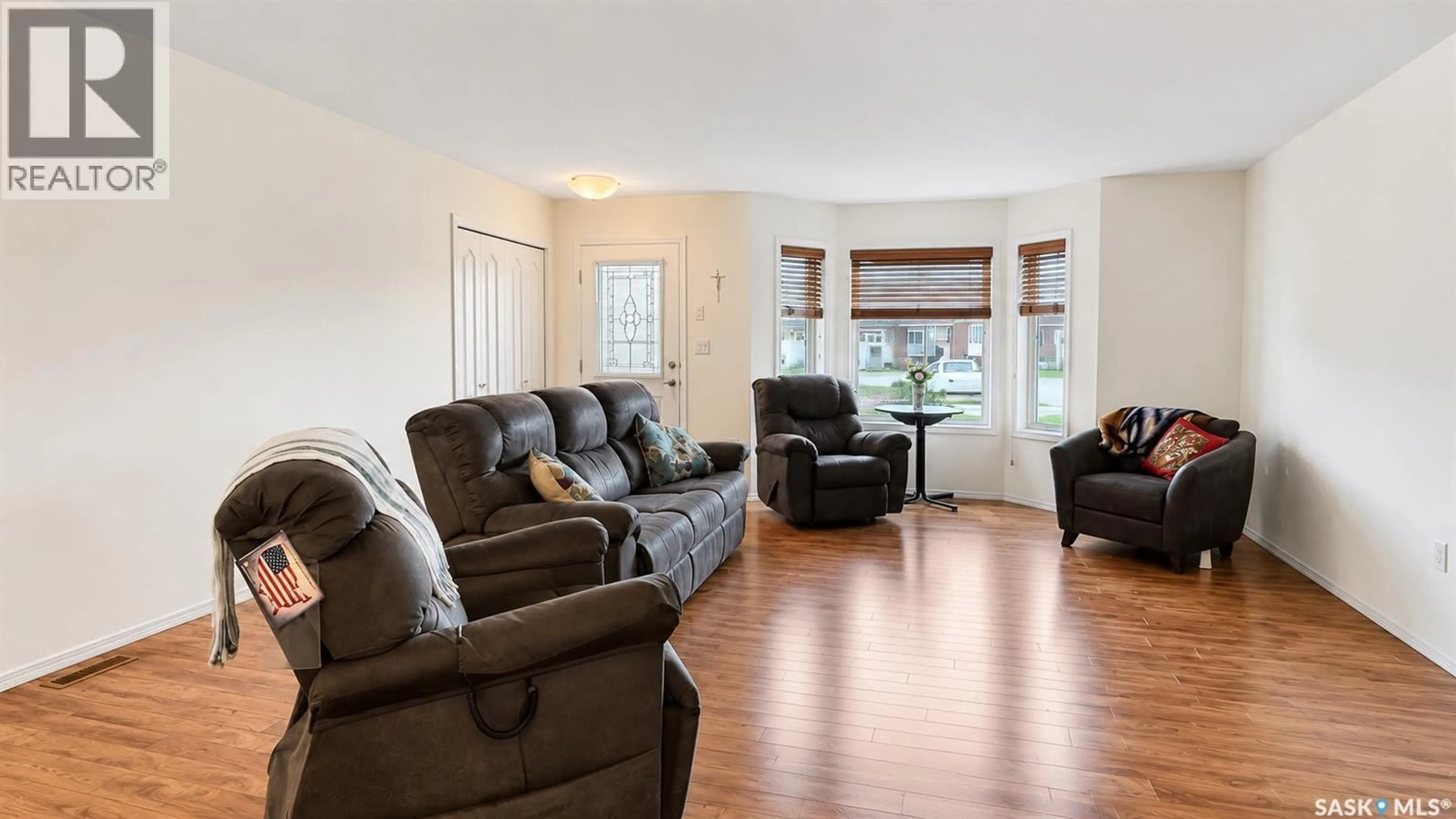 Living room with furniture, wood/laminate floor for 2419 BUHLER AVENUE, North Battleford Saskatchewan S9A1R2