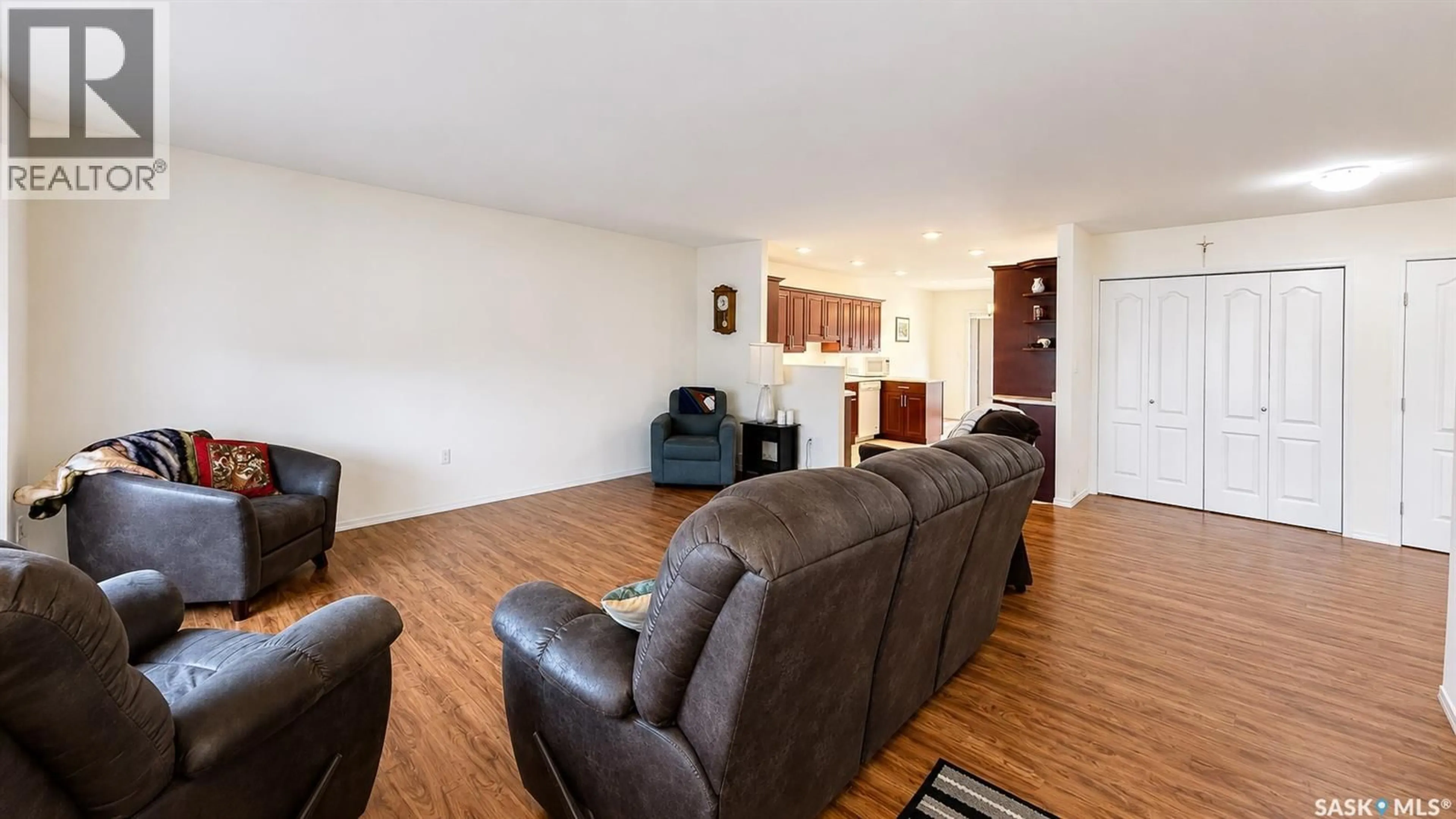 Living room with furniture, wood/laminate floor for 2419 BUHLER AVENUE, North Battleford Saskatchewan S9A1R2