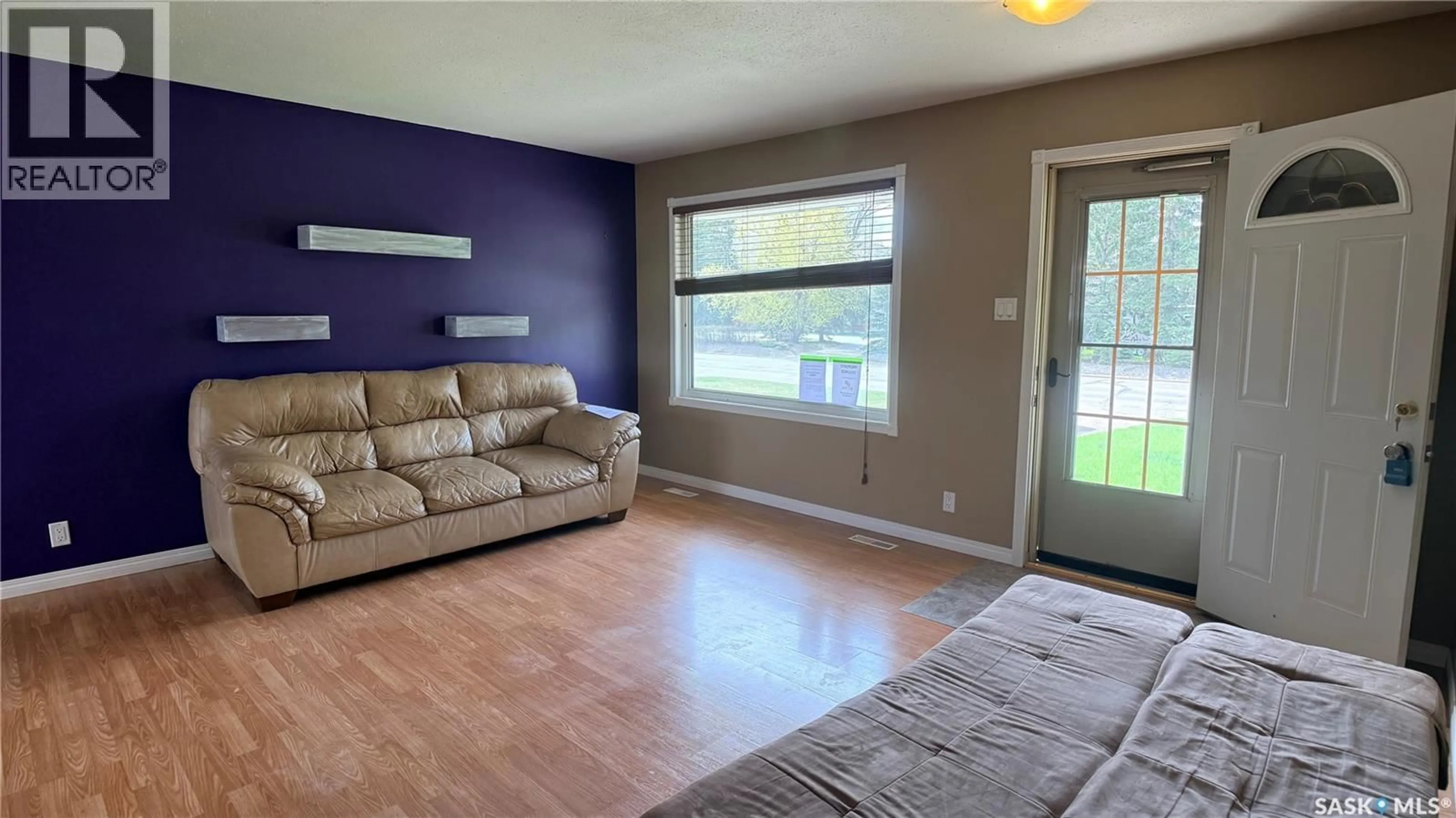 Living room with furniture, wood/laminate floor for 1276 KING STREET, Estevan Saskatchewan S4A1L5