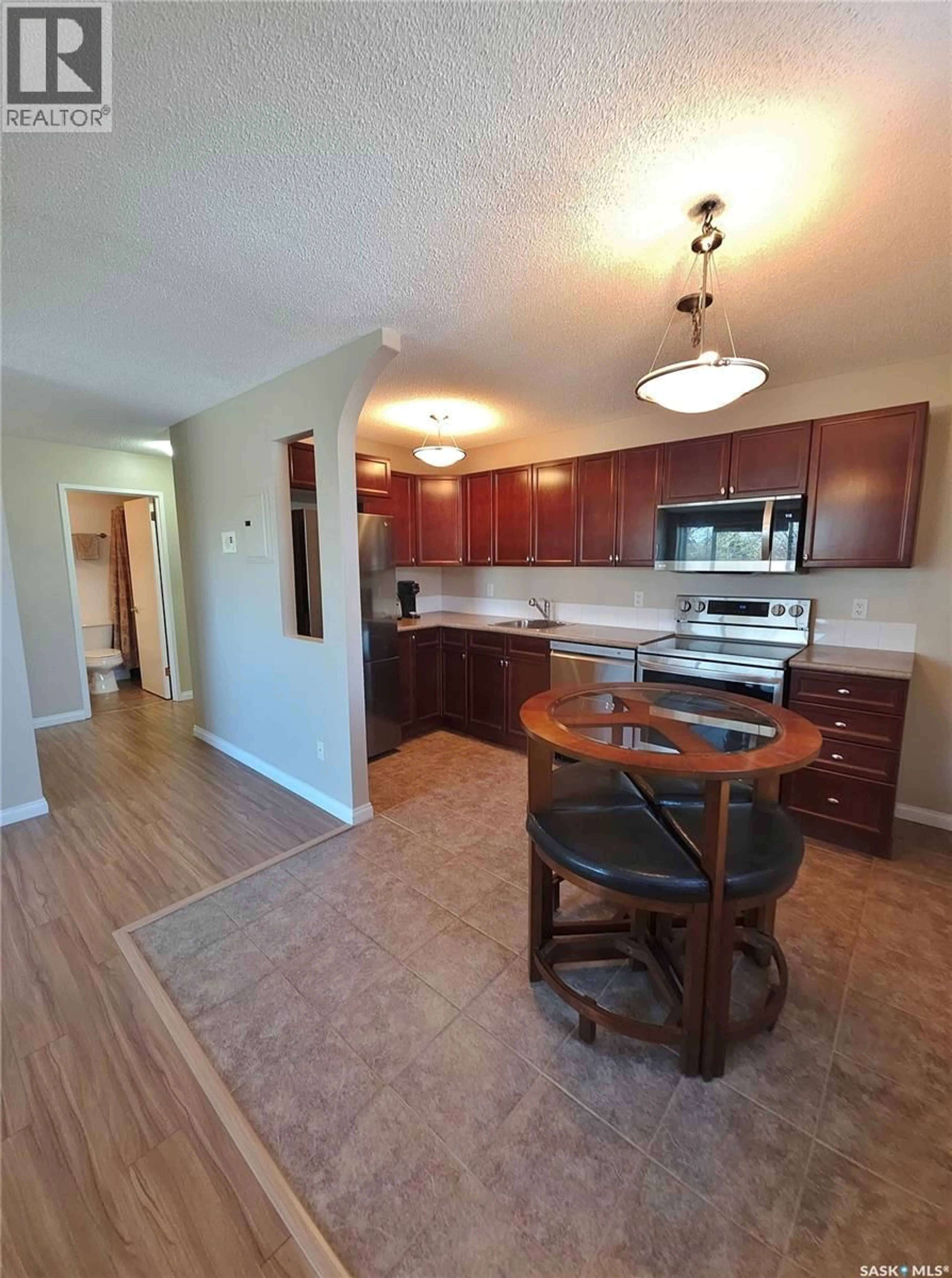 Open concept kitchen, wood/laminate floor for N - 316 1223 7TH AVENUE, Saskatoon Saskatchewan S7K2W1