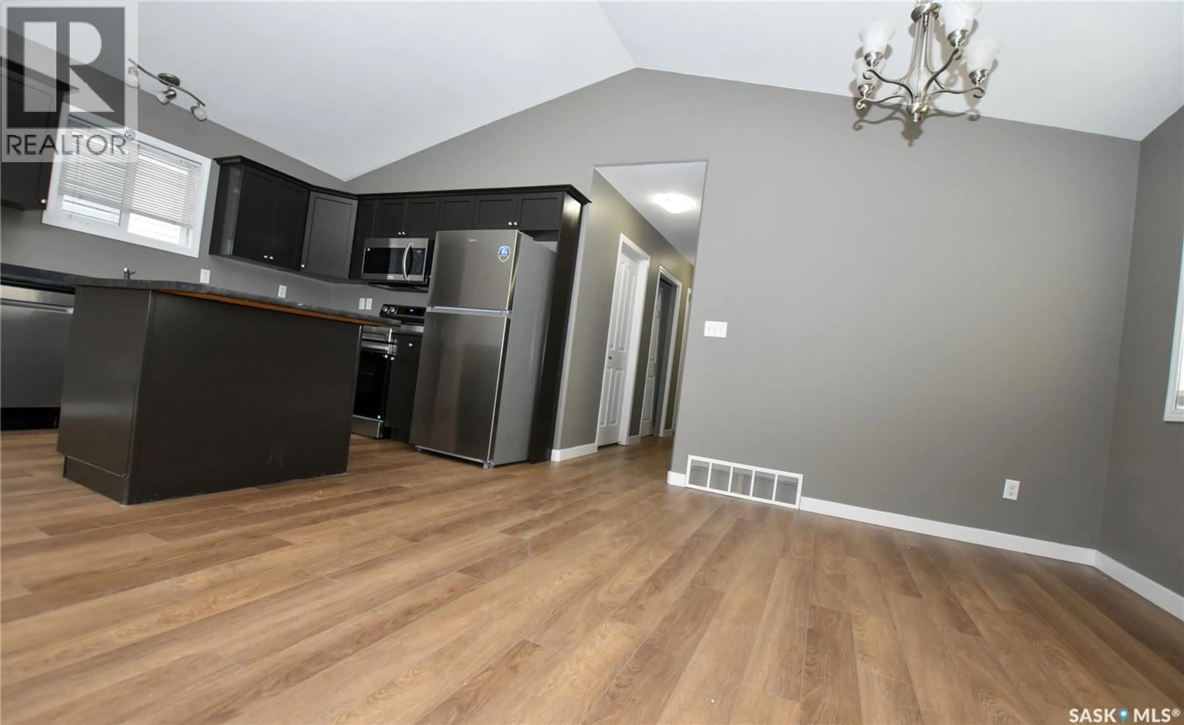 Open concept kitchen, wood/laminate floor for 106 GEARY CRESCENT, Saskatoon Saskatchewan S7R0B8
