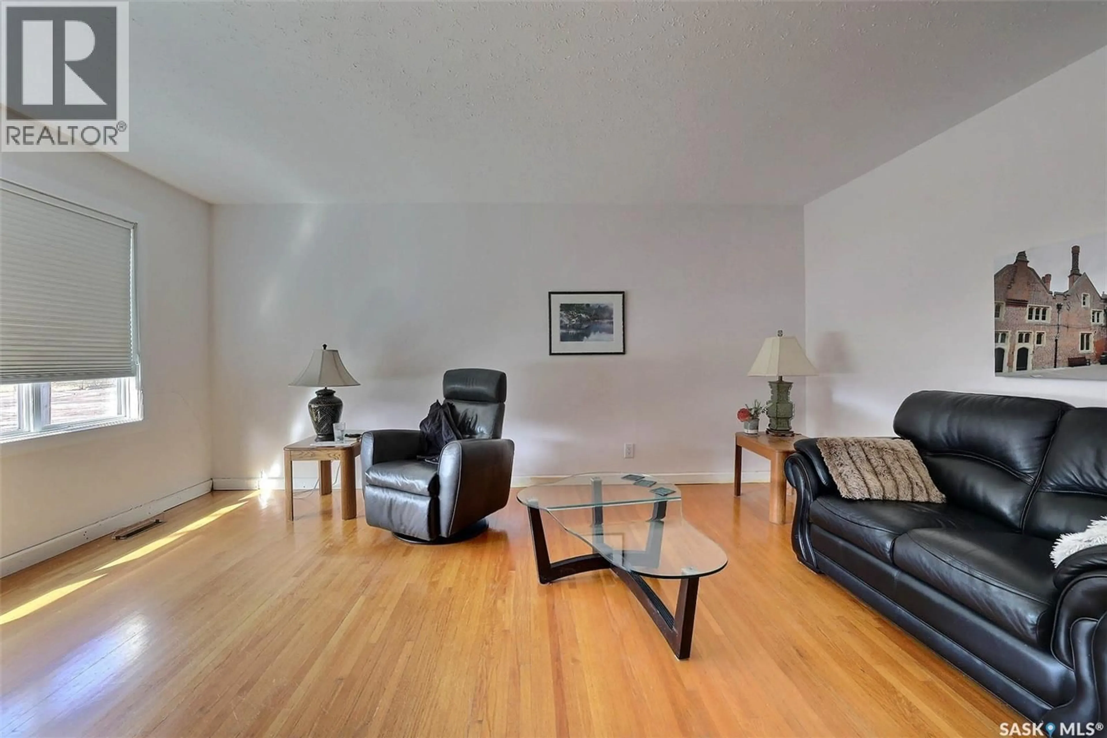 Living room with furniture, wood/laminate floor for 55 FOX GLOVE CRESCENT, Regina Saskatchewan S4S4K8