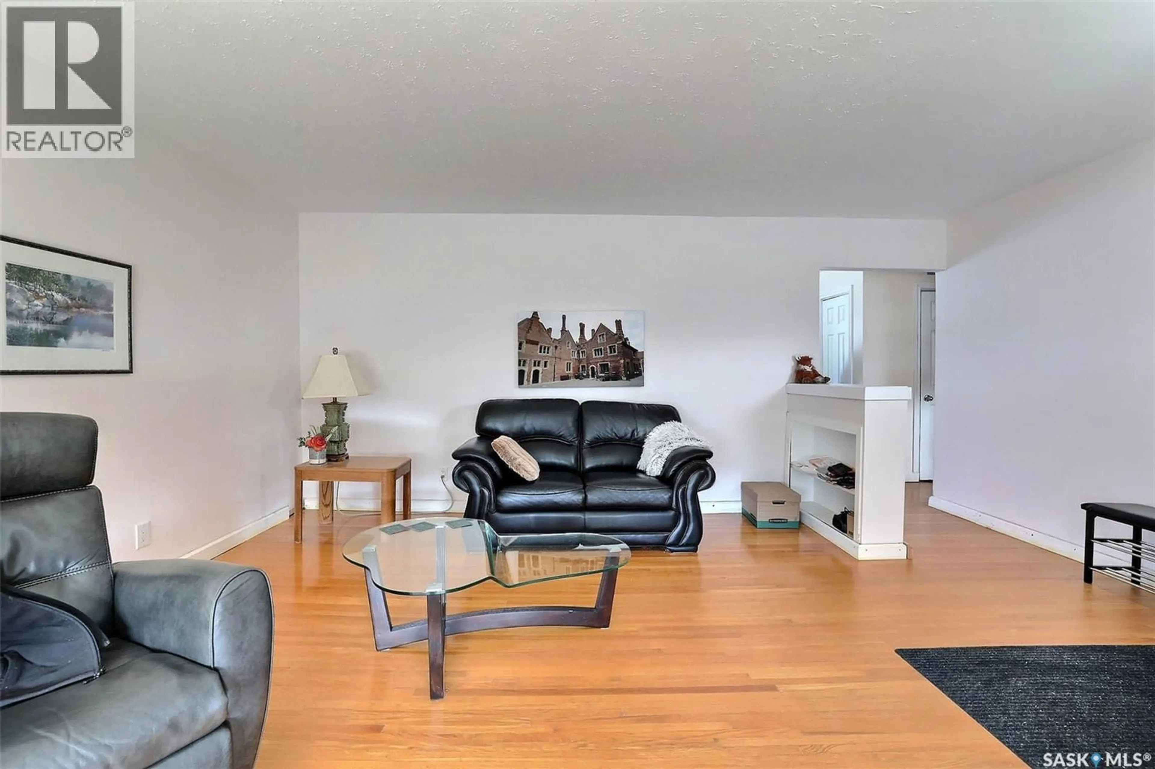 Living room with furniture, wood/laminate floor for 55 FOX GLOVE CRESCENT, Regina Saskatchewan S4S4K8