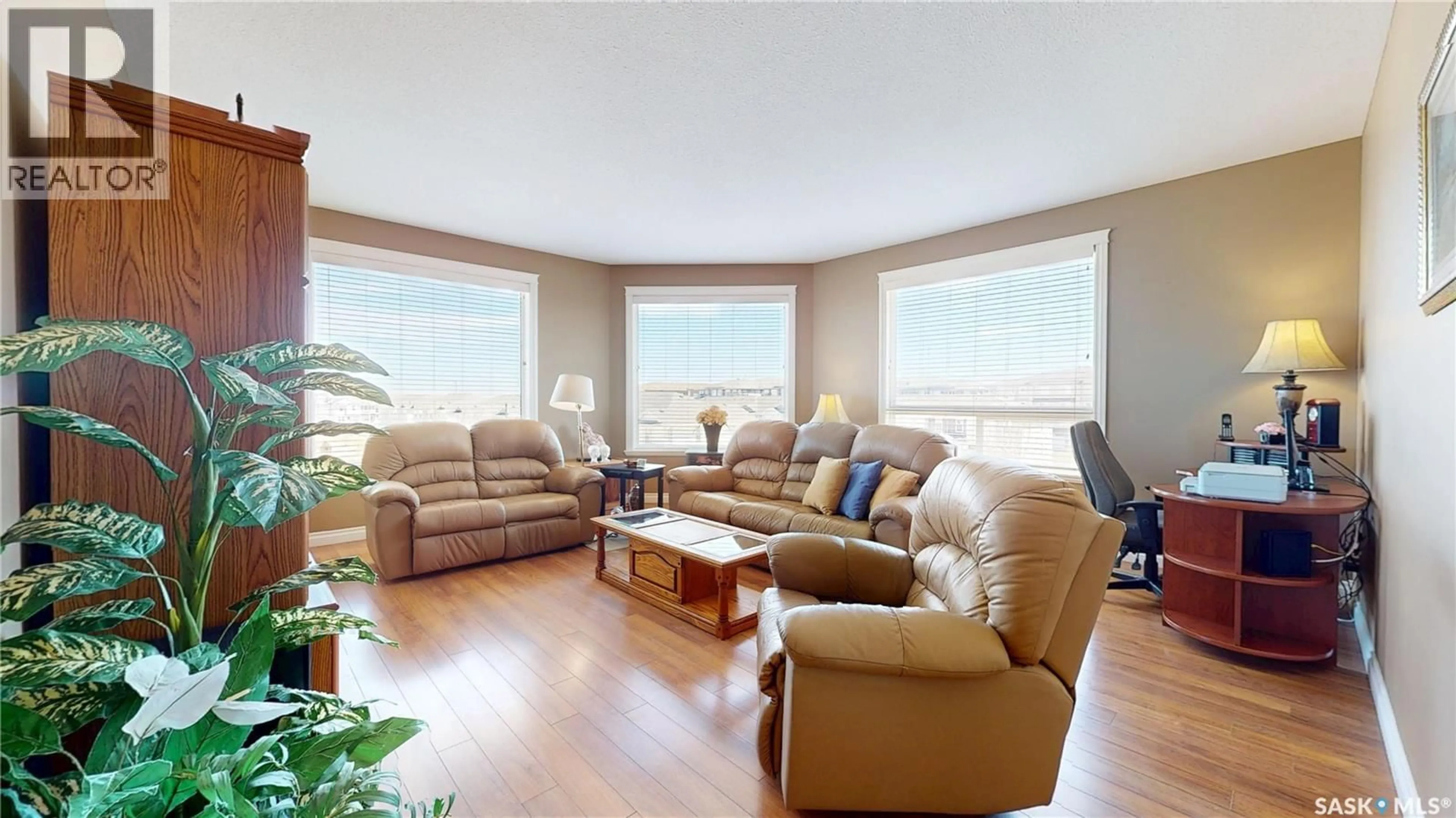Living room with furniture, wood/laminate floor for 3750 HAUGHTON ROAD, Regina Saskatchewan S4V1R6