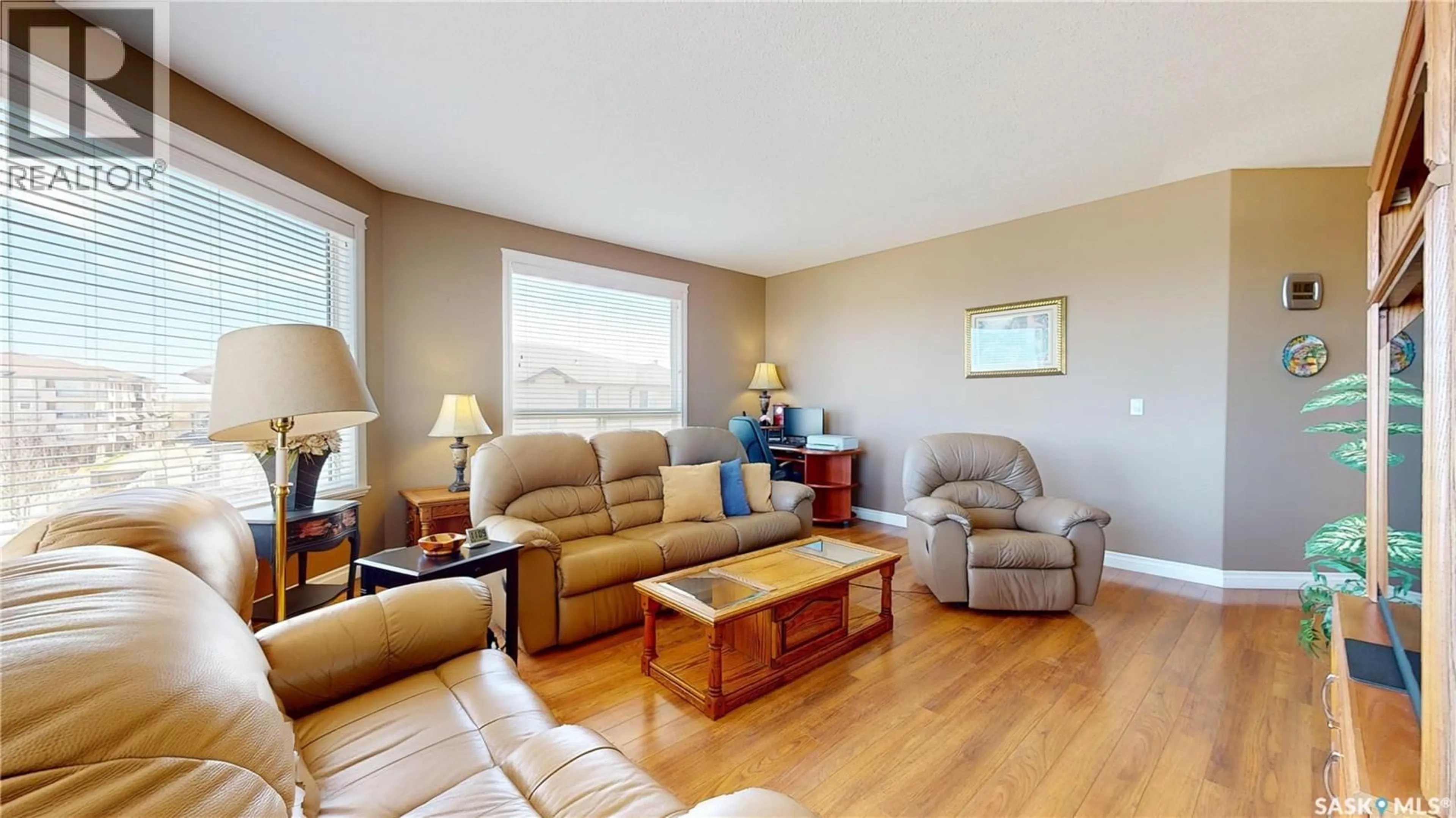 Living room with furniture, wood/laminate floor for 3750 HAUGHTON ROAD, Regina Saskatchewan S4V1R6
