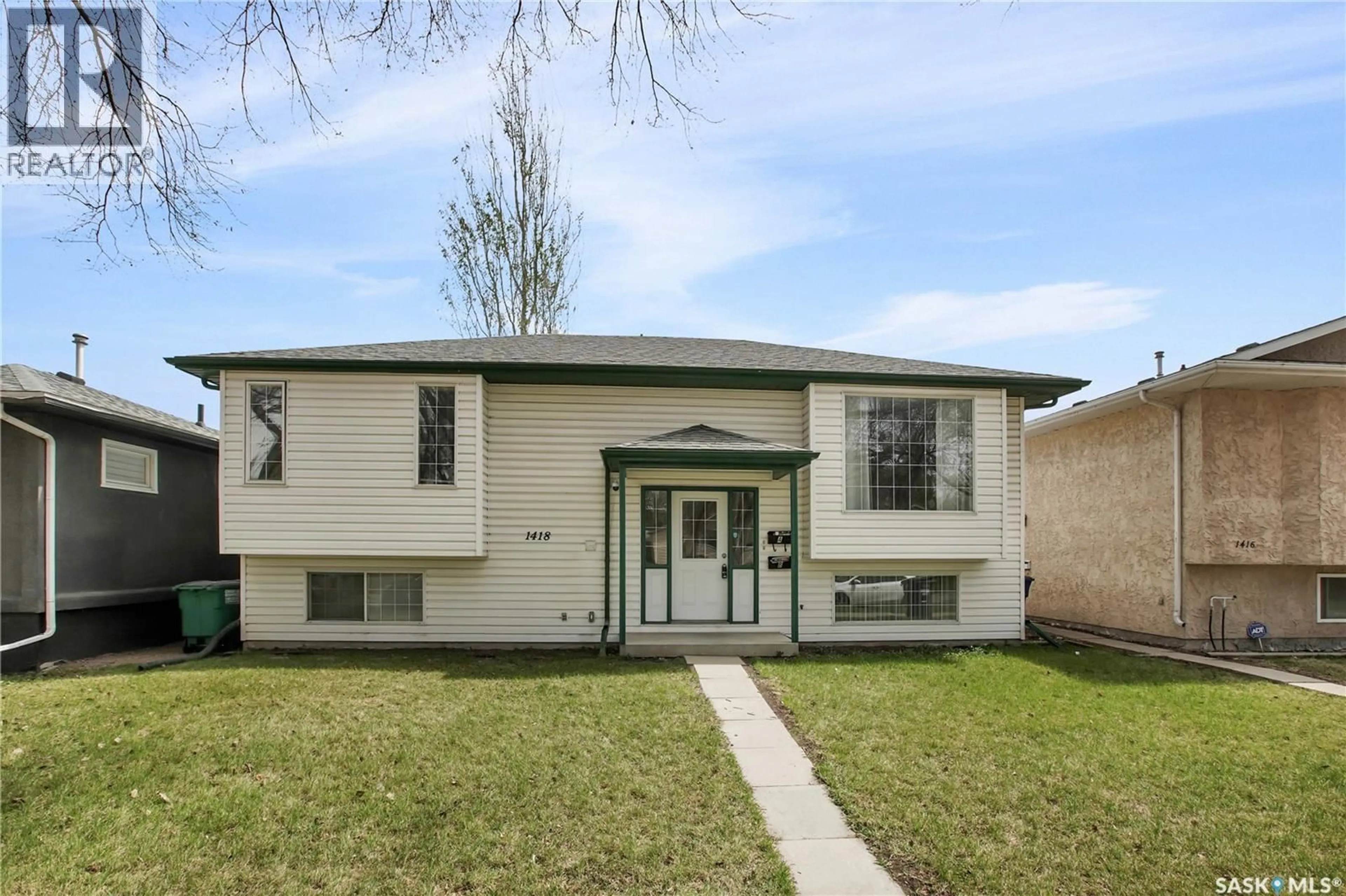 Home with vinyl exterior material, street for 1418 B AVENUE, Saskatoon Saskatchewan S7L1G8