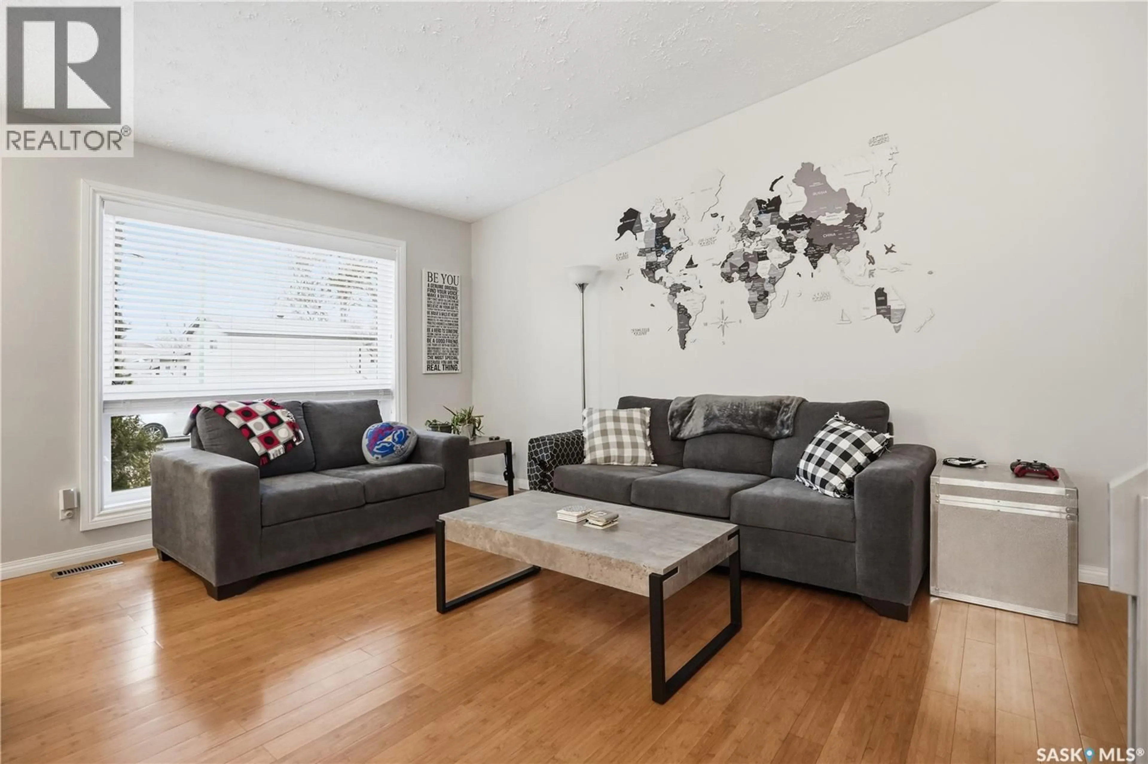 Living room with furniture, wood/laminate floor for 2838 HARTMANN CRESCENT, Regina Saskatchewan S4N6L9