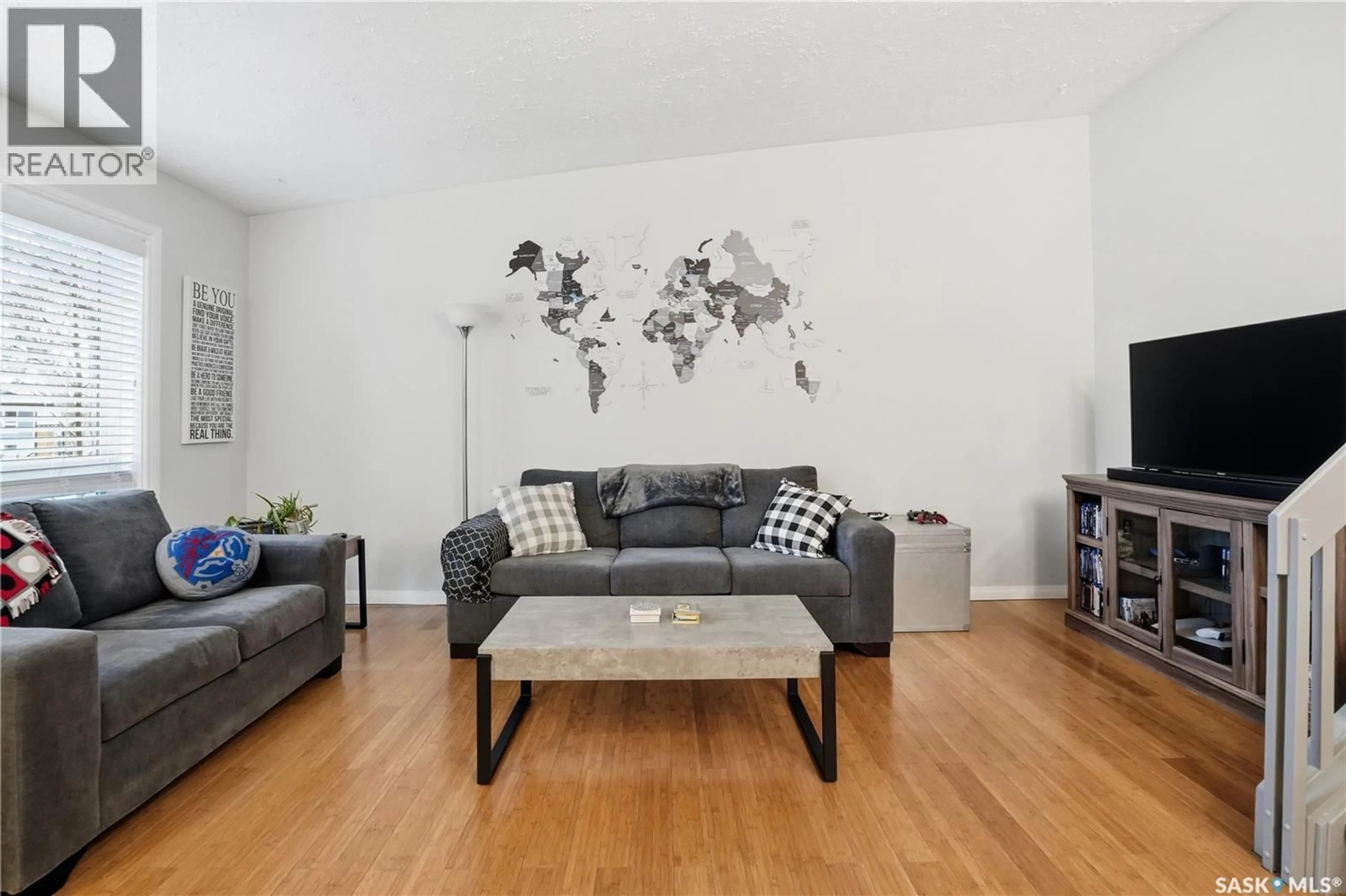 Living room with furniture, wood/laminate floor for 2838 HARTMANN CRESCENT, Regina Saskatchewan S4N6L9